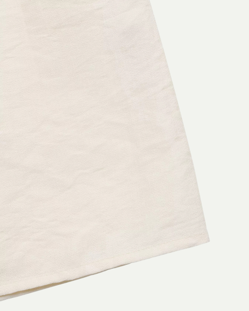 Beige fabric detail dress lightweight smooth texture close up
