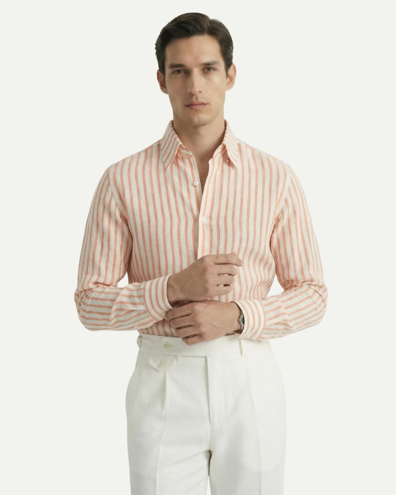 Male model wearing an orange striped linen button-up shirt in a smart-casual look
