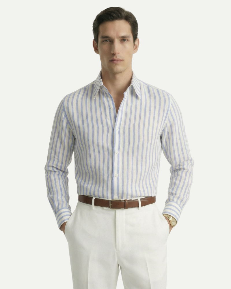 Male model wearing a blue striped linen button-up shirt with a relaxed fit
