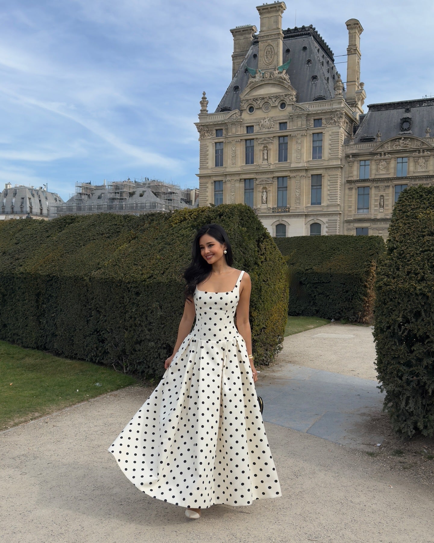 White polka dot midi dress women elegant outfit Paris background summer look
