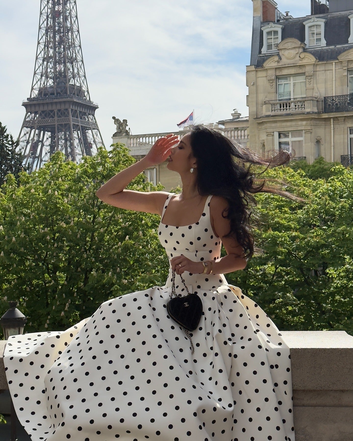 White polka dot midi dress women flowing skirt sitting Paris balcony outfit
