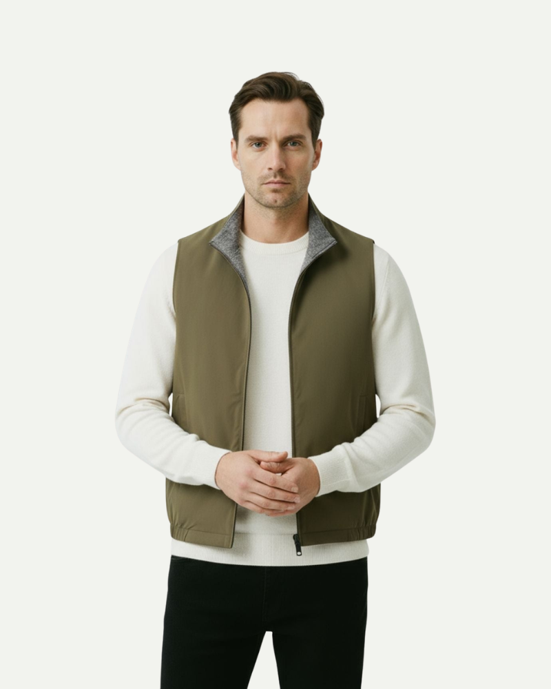 Male model wearing an olive green reversible zip-up vest with stand collar
