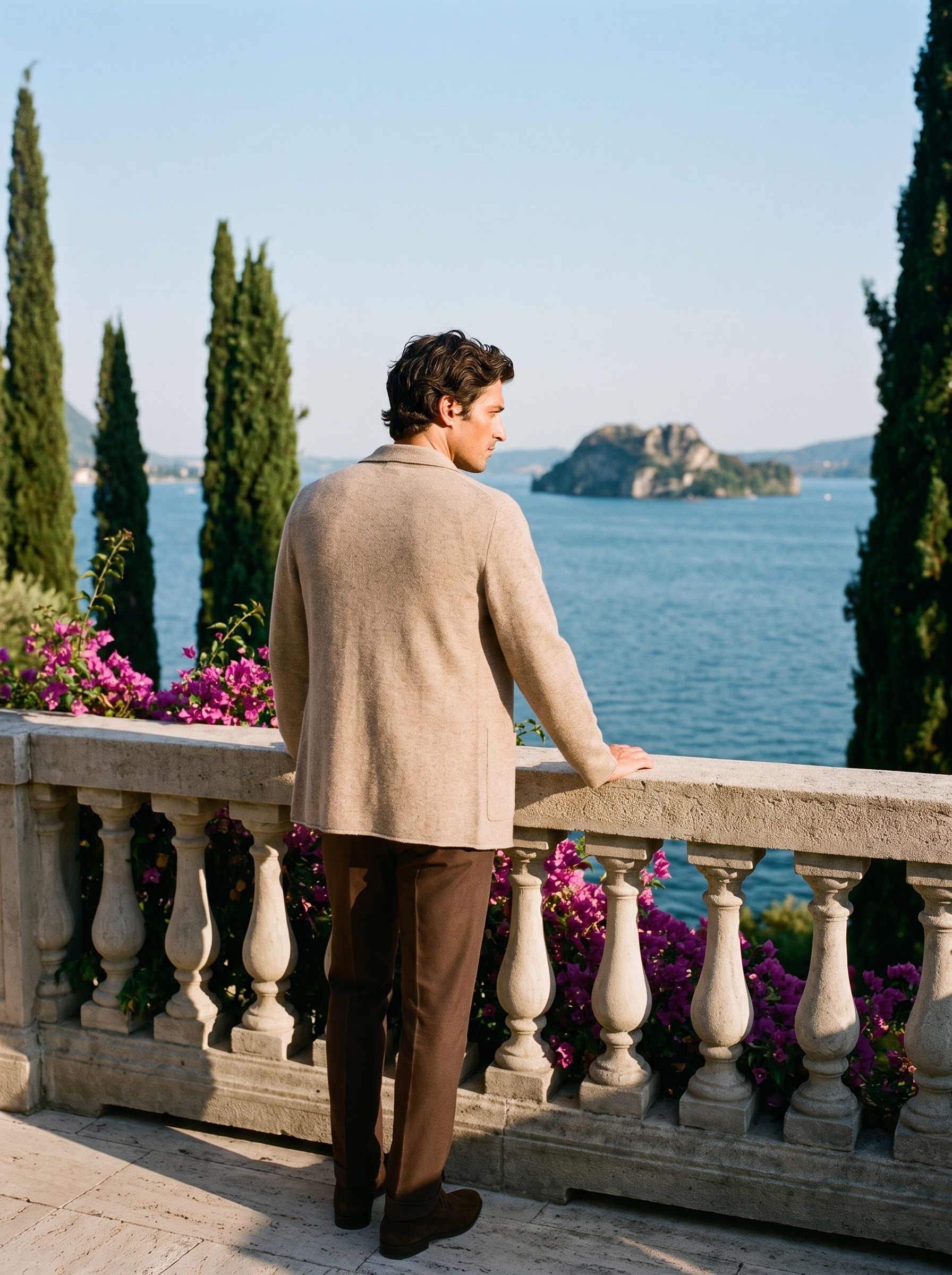 Back view of a beige wool blazer cardigan worn on a Mediterranean terrace — Aveloire