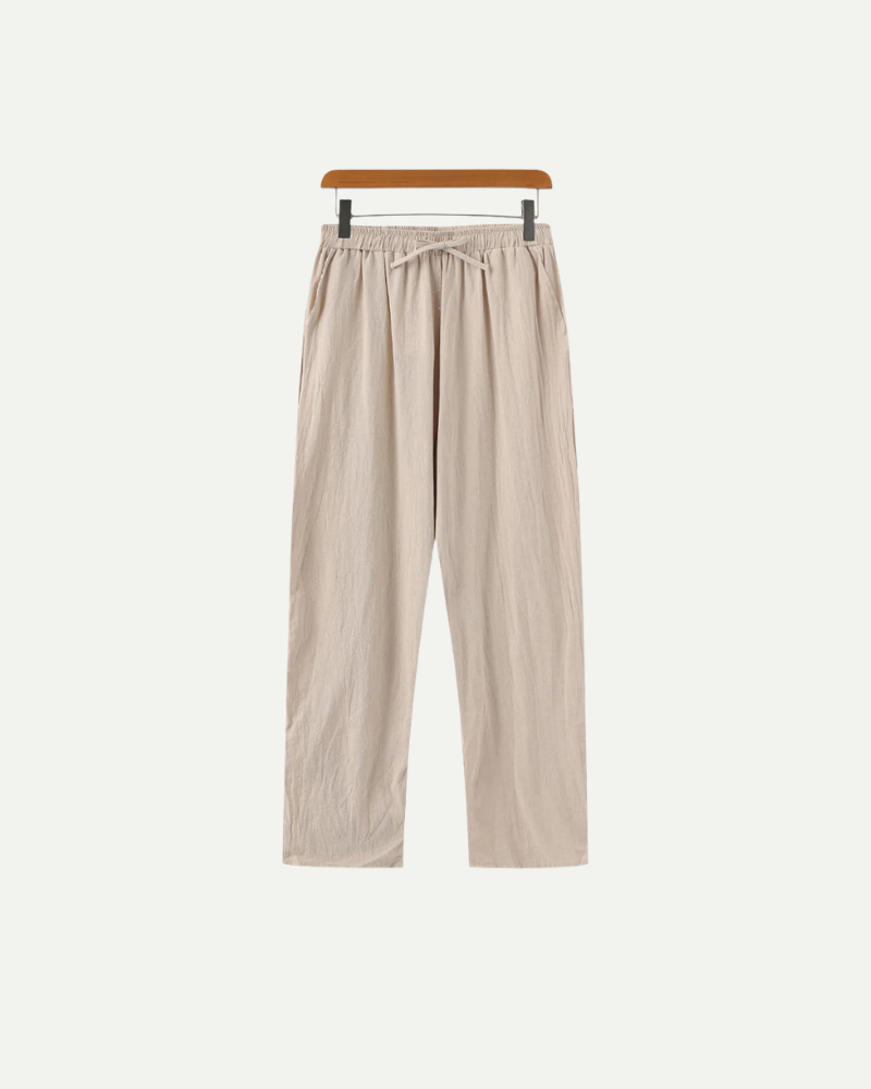 Beige pants on a hanger against a white background