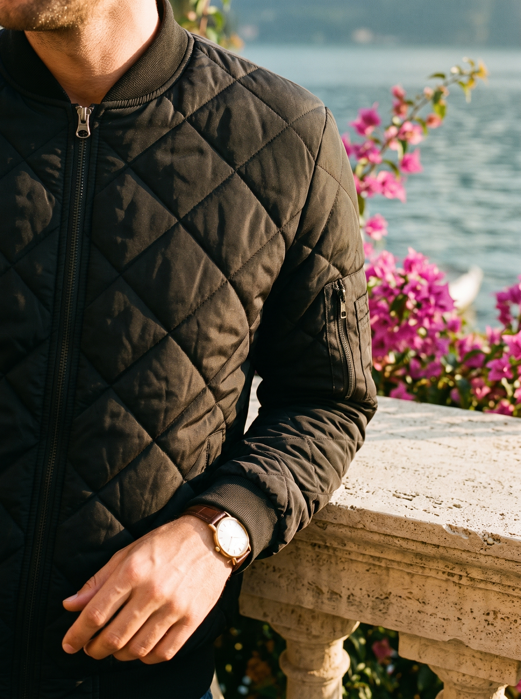 Black quilted bomber jacket collar and zip detail with gold watch, Lake Como, old money style — Aveloire