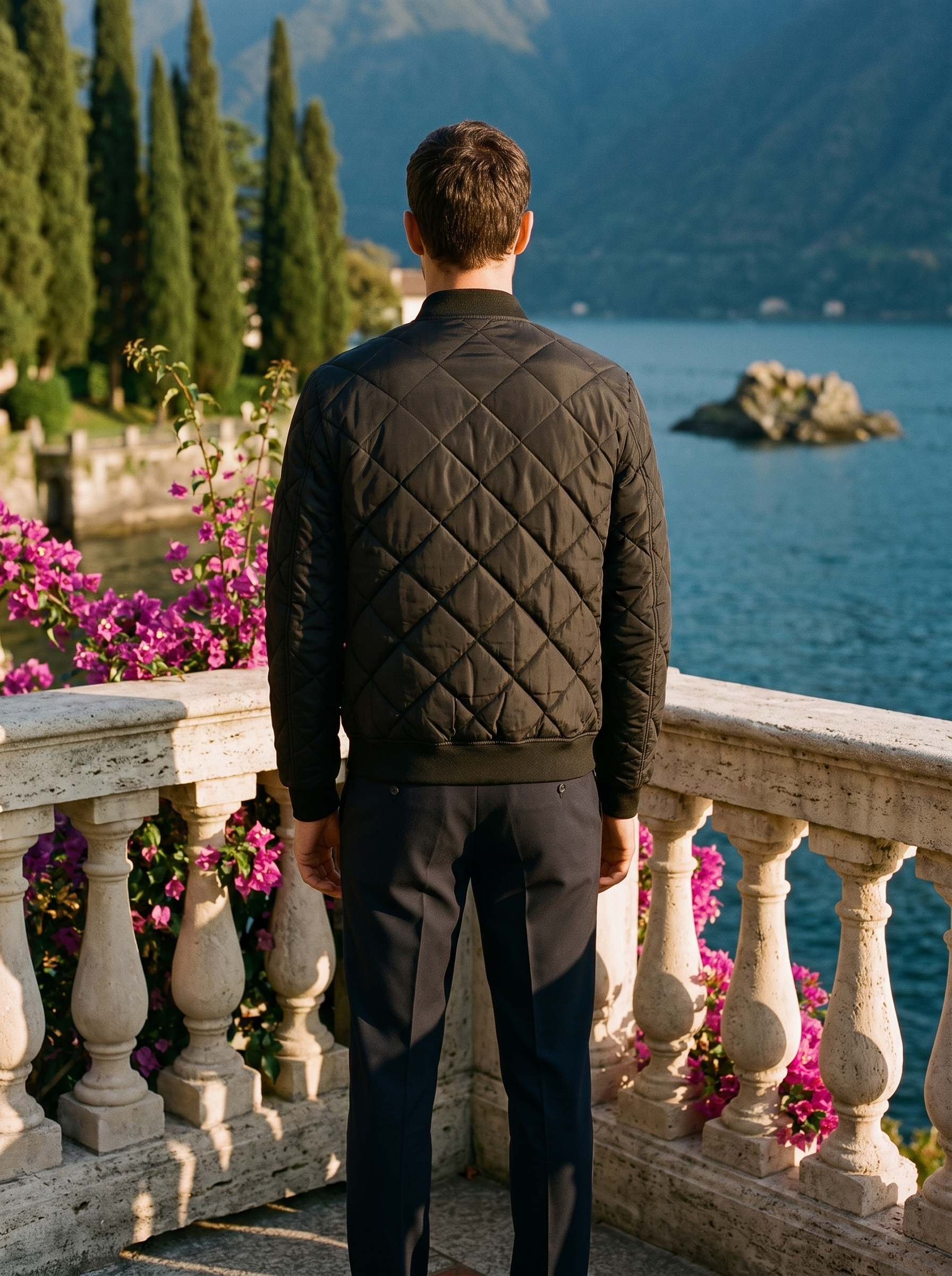 Man wearing a black quilted bomber jacket, full-length back view on a Lake Como terrace, old money style — Aveloire