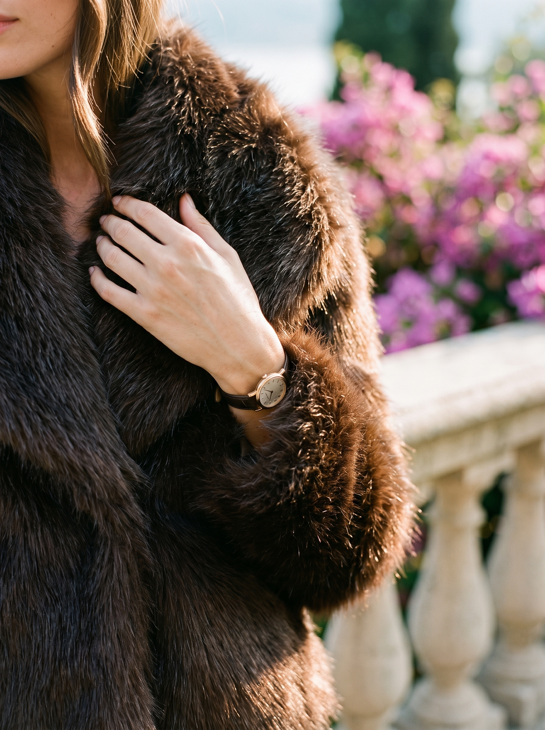 Close-up of the plush faux fur texture on a brown cropped coat — Aveloire