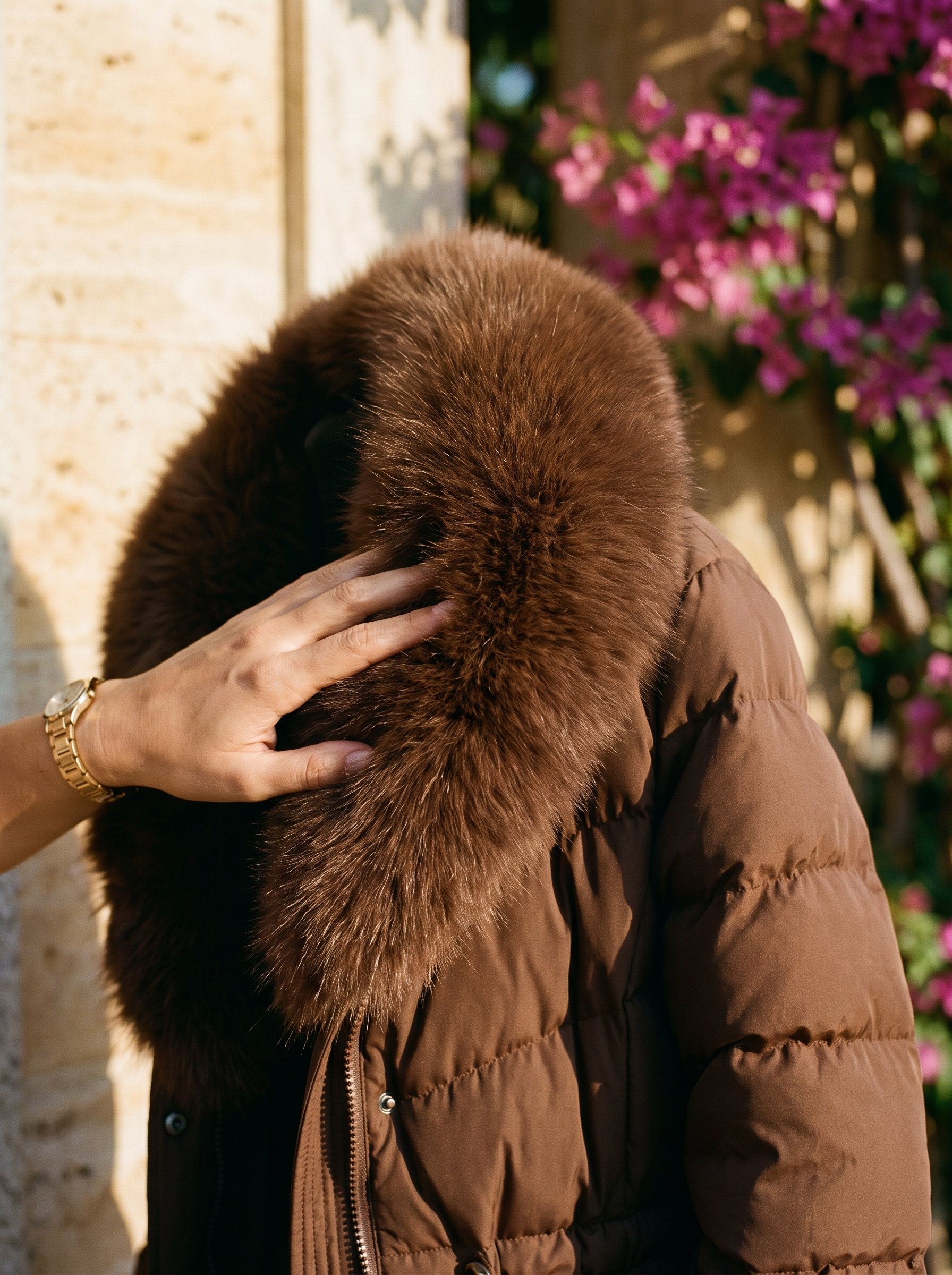 Brown fur-hood puffer coat quilted channels and fur trim detail