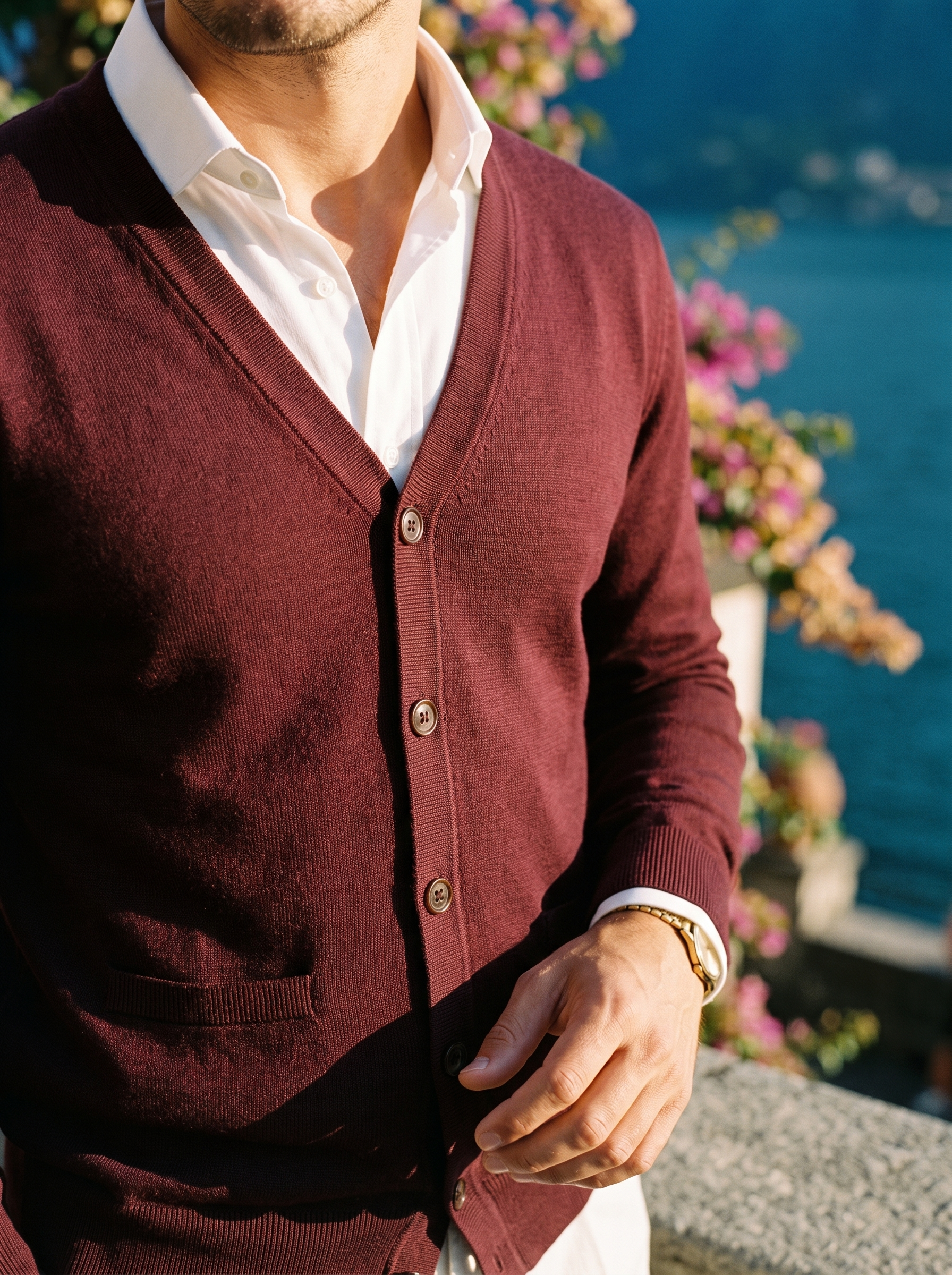 V-neck line, buttons and fine knit texture detail of a burgundy cardigan — Aveloire