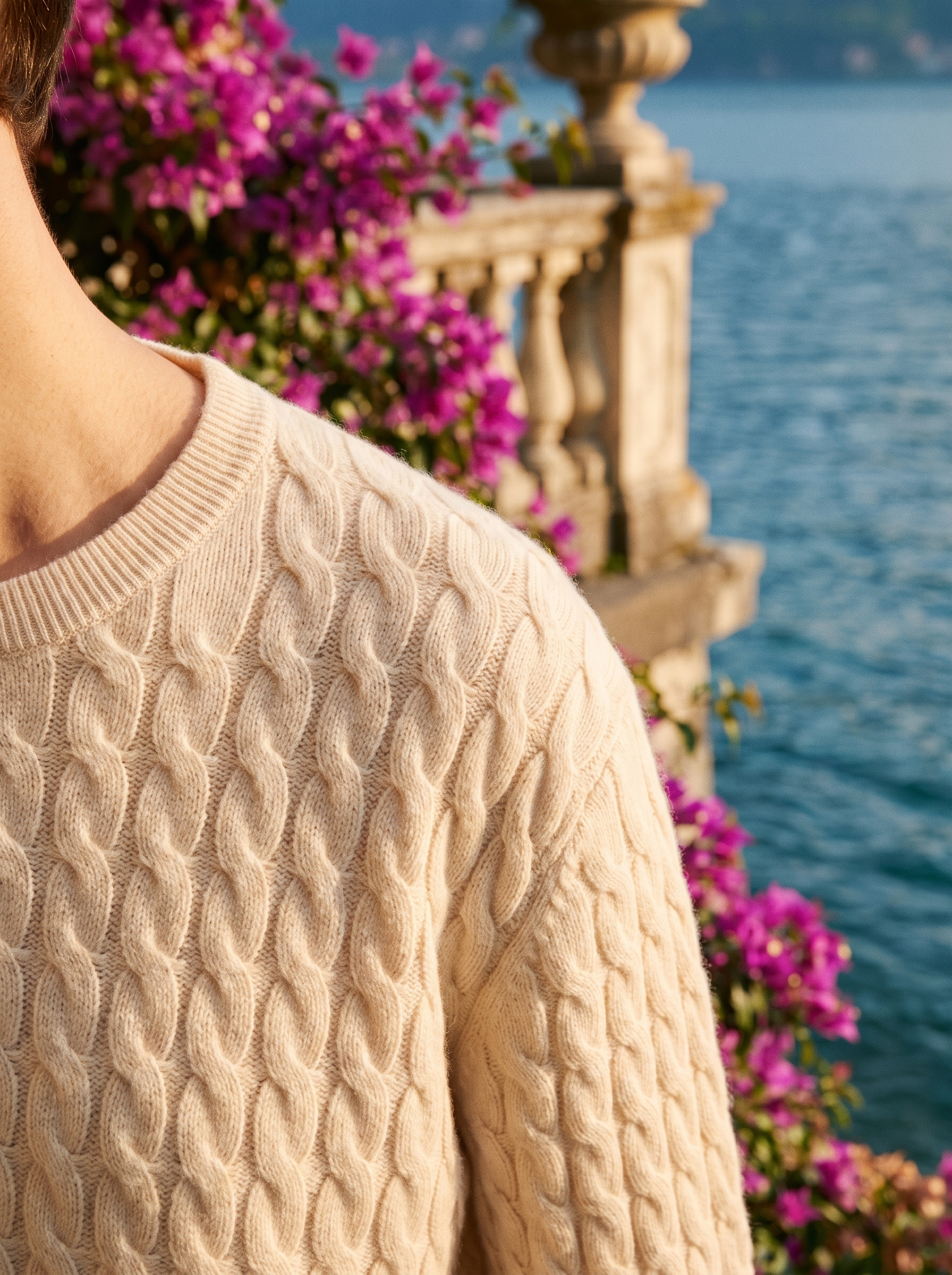Close-up of the twisted cable-knit texture of a cream jumper — Aveloire