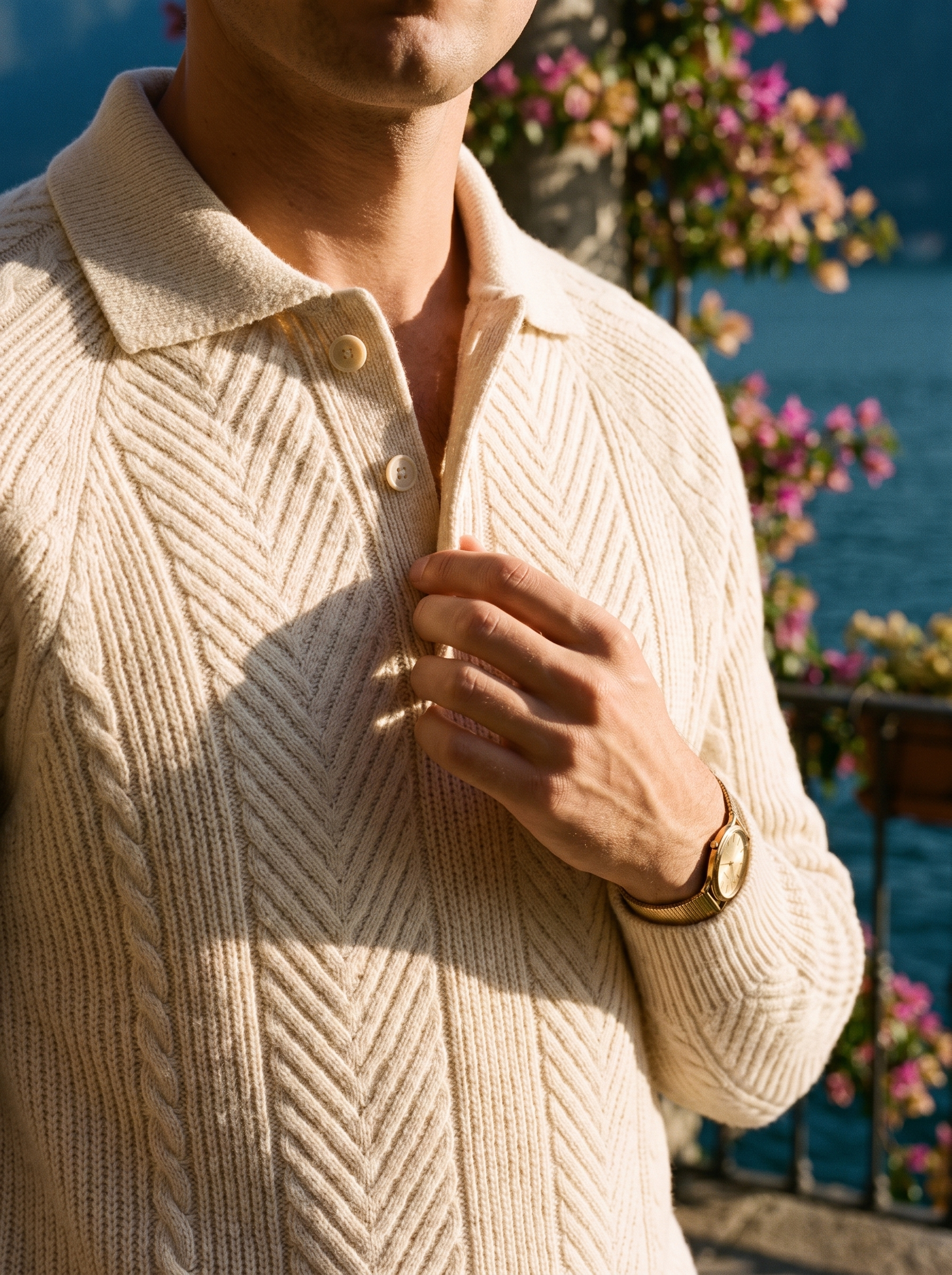 Knitted polo collar and button placket detail of a cream herringbone knit sweater — Aveloire