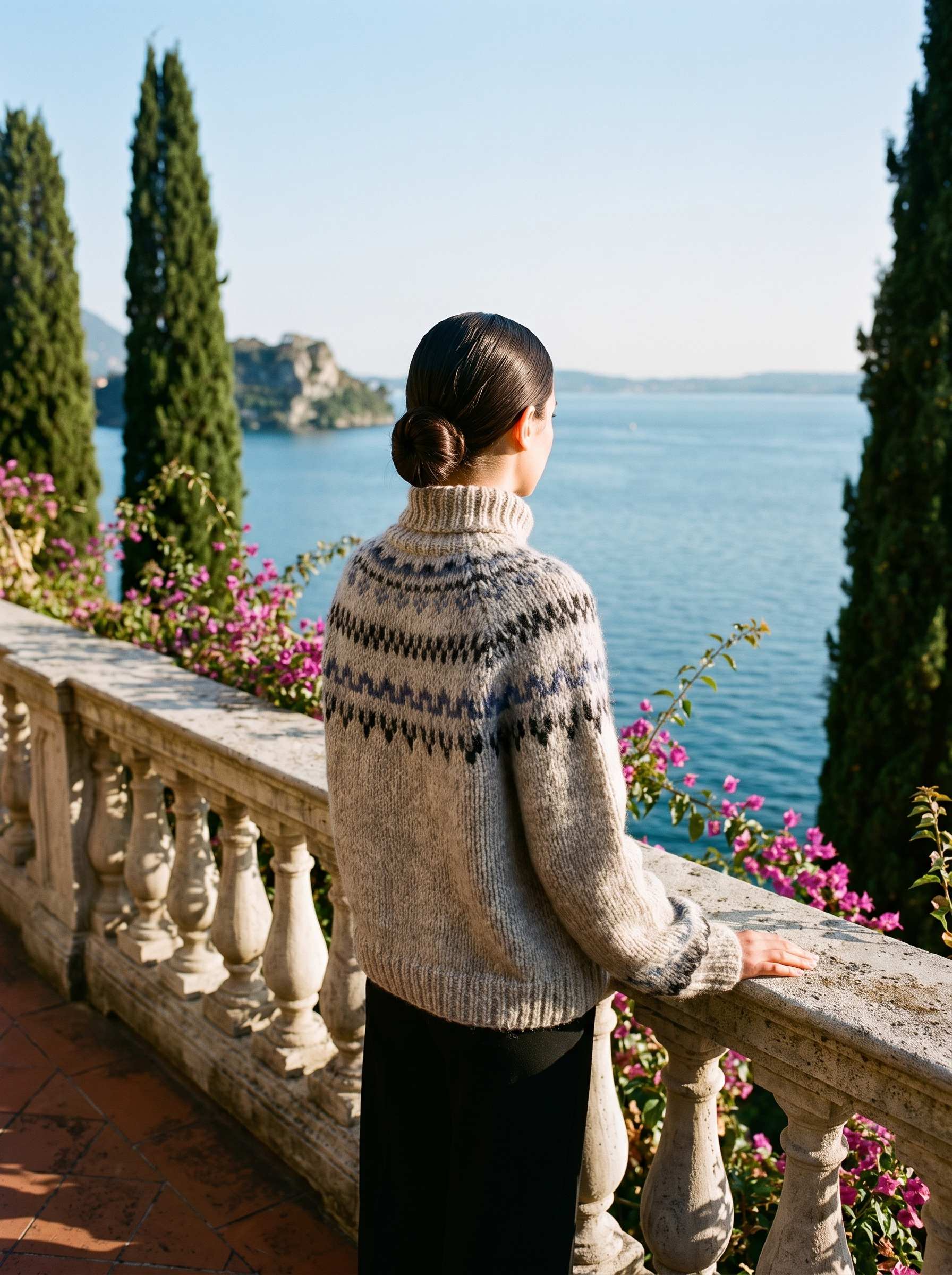 Back view of a grey Fair Isle roll-neck jumper on a Lake Como terrace — Aveloire