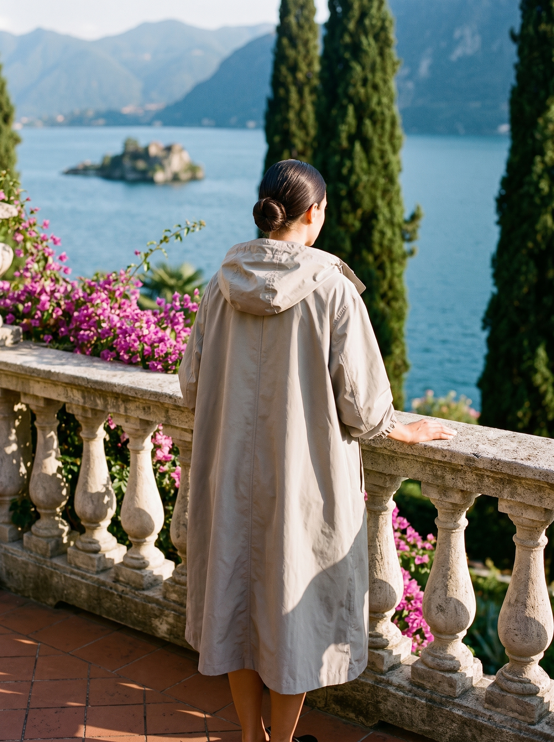 Stone grey water-repellent hooded raincoat back view at balustrade