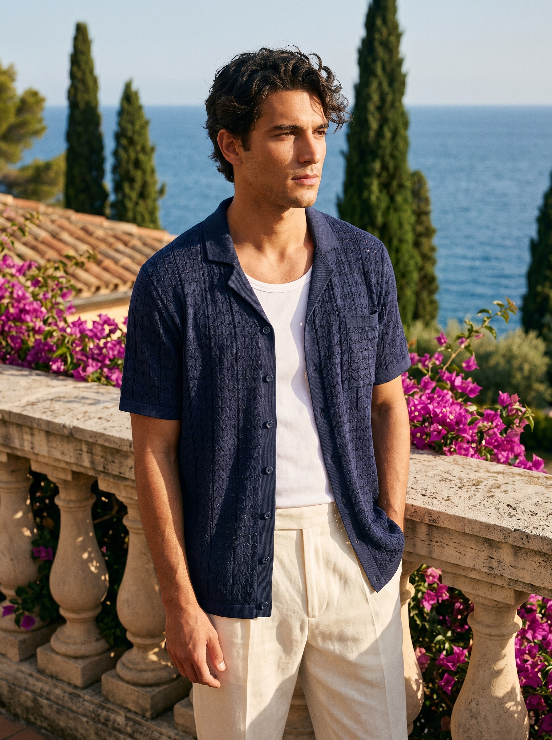 Man wearing a navy textured knit pocket shirt on a balcony overlooking Lake Como, old money style — Aveloire
