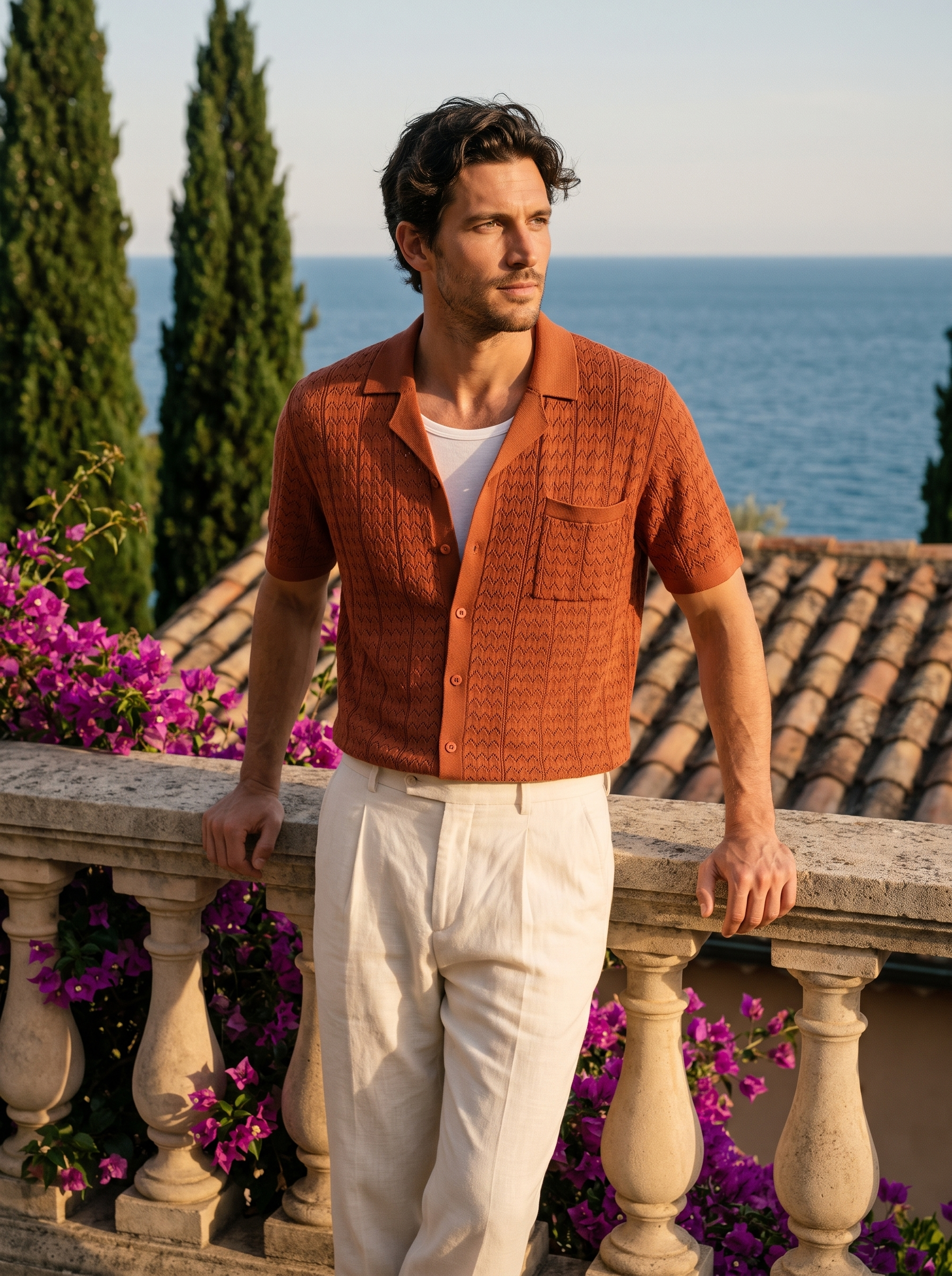 Man wearing a burnt orange textured knit pocket shirt on a balcony overlooking Lake Como, old money style — Aveloire