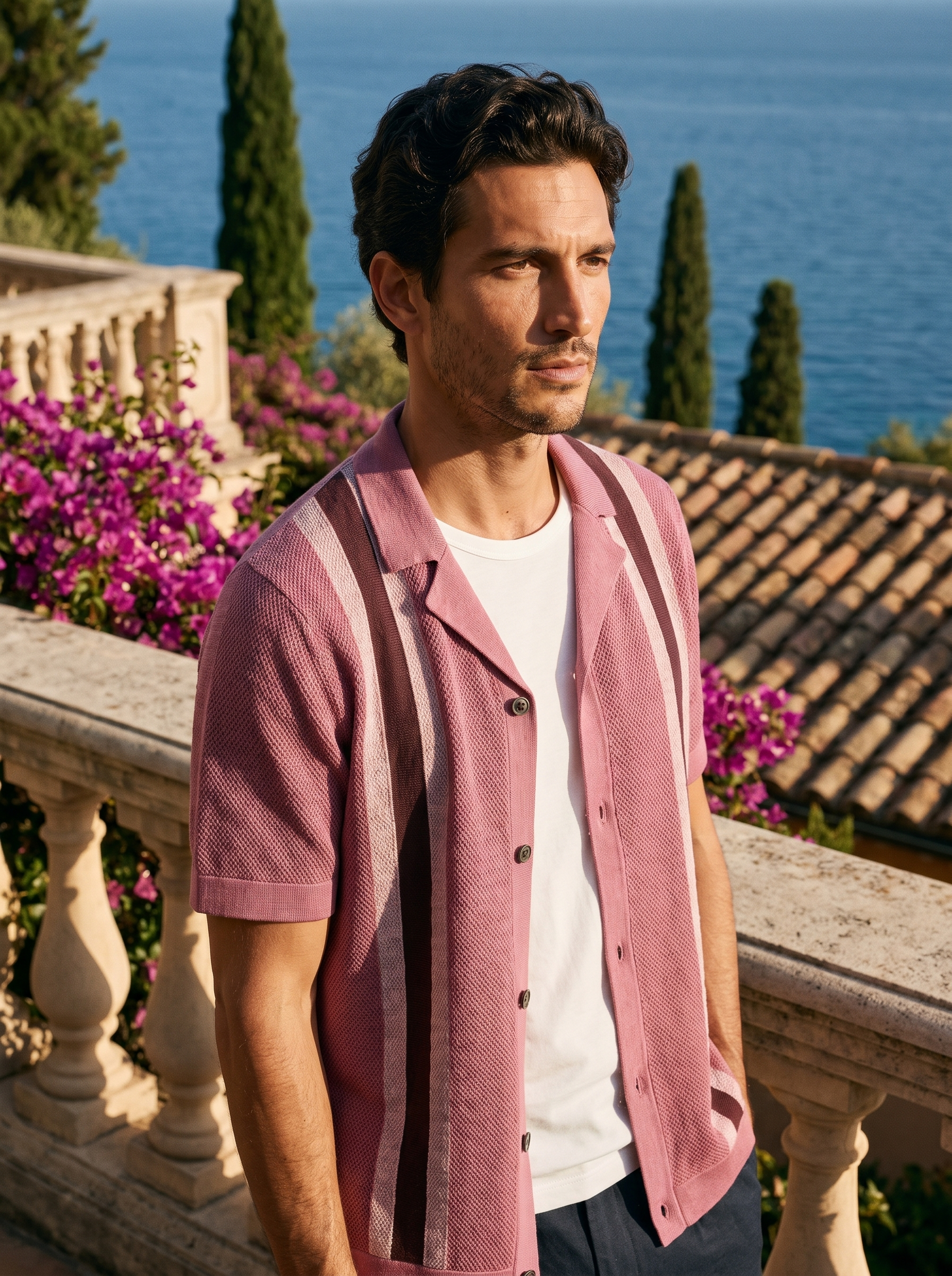 Man wearing a dusty rose striped open-knit camp collar shirt on a balcony overlooking Lake Como, old money style — Aveloire
