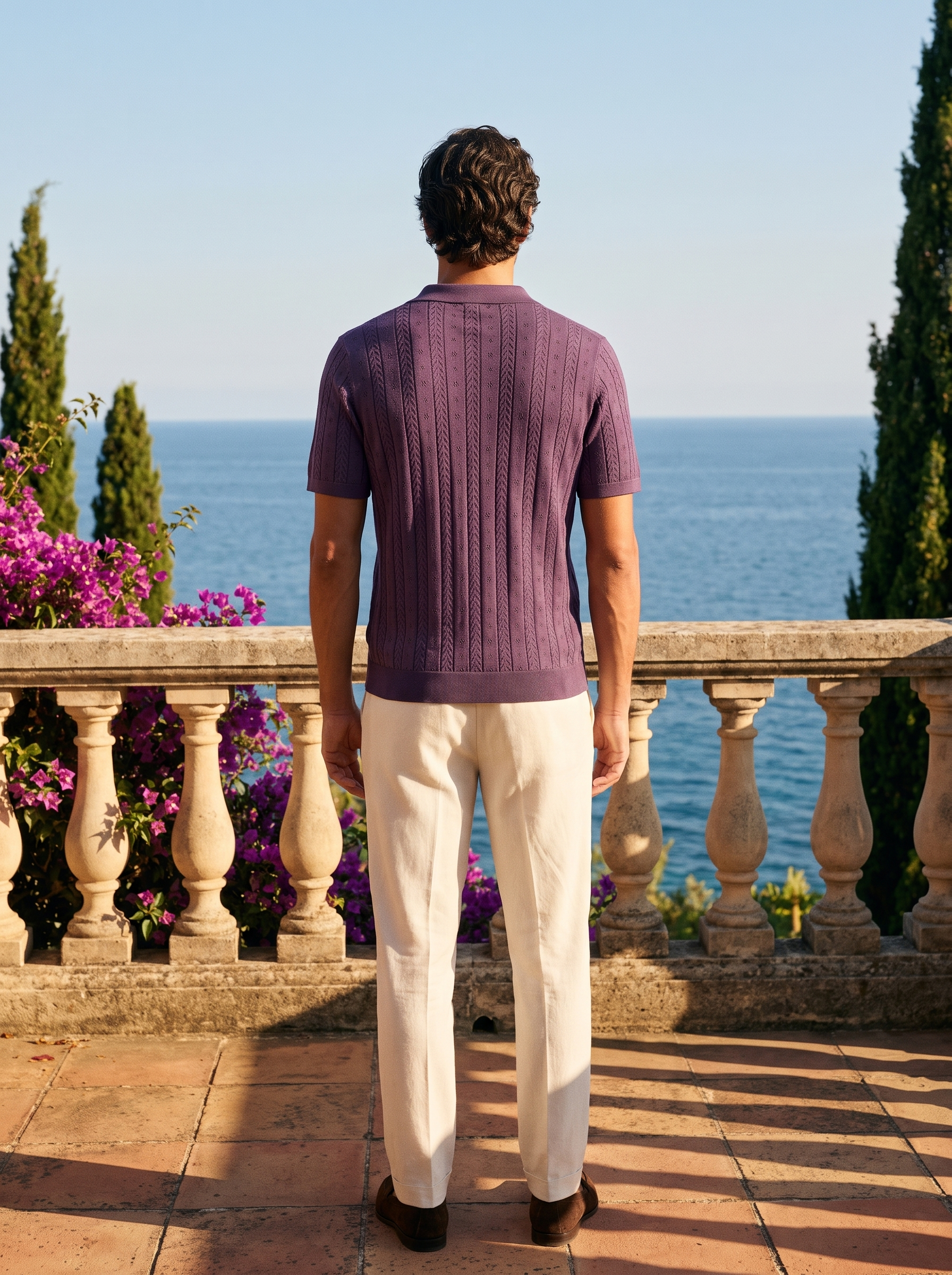 Back view of a man in a purple textured knit polo overlooking Lake Como — Aveloire