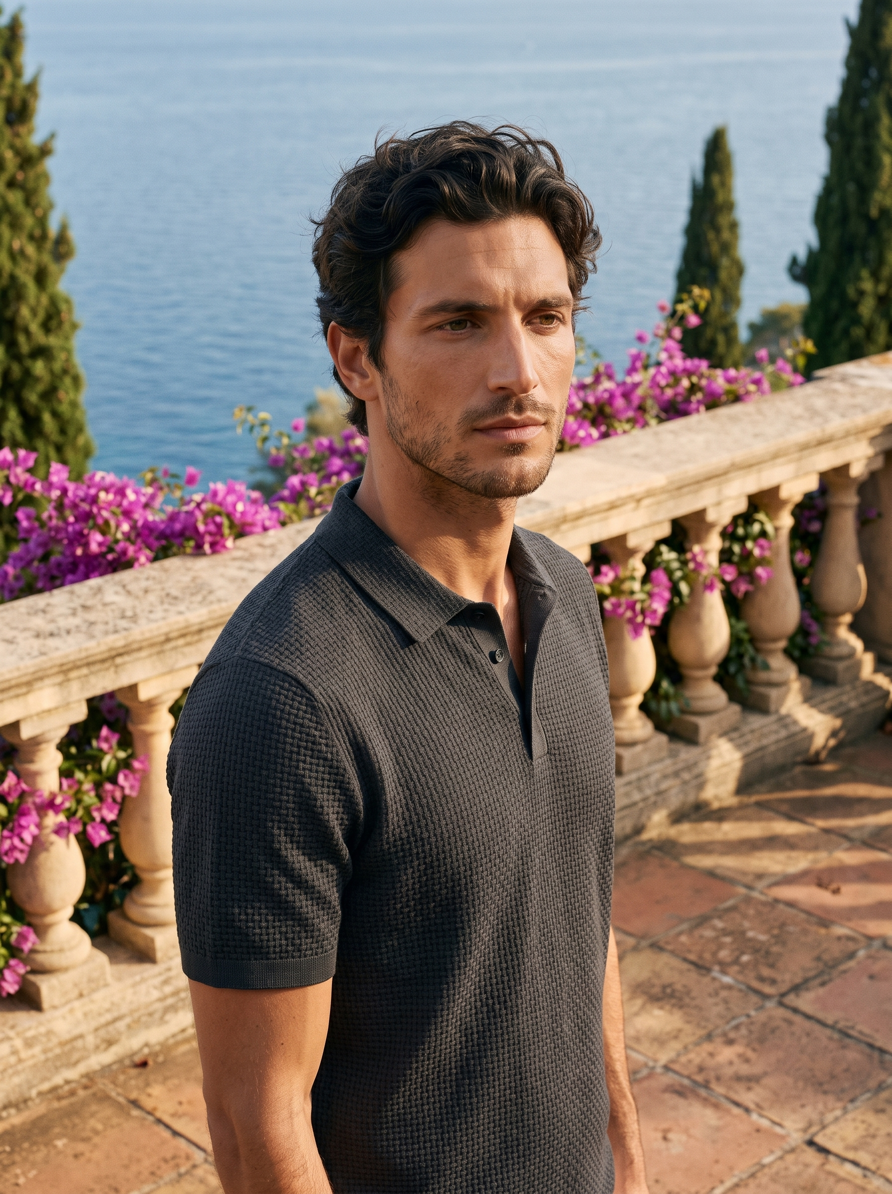 Man wearing a grey basketweave knit polo on a balcony overlooking Lake Como, old money style — Aveloire