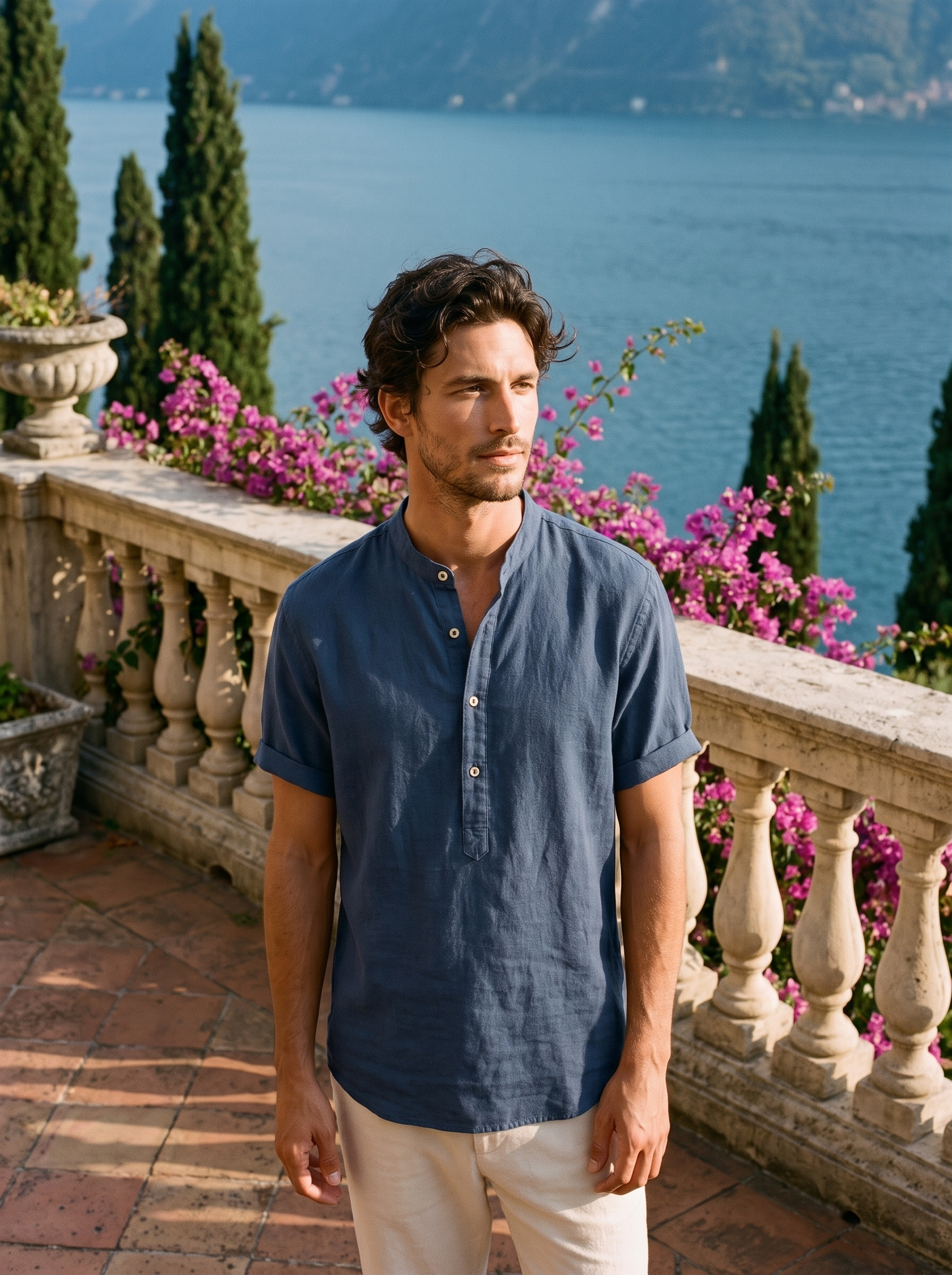 Man wearing a navy band-collar linen shirt on a balcony overlooking Lake Como, old money style — Aveloire