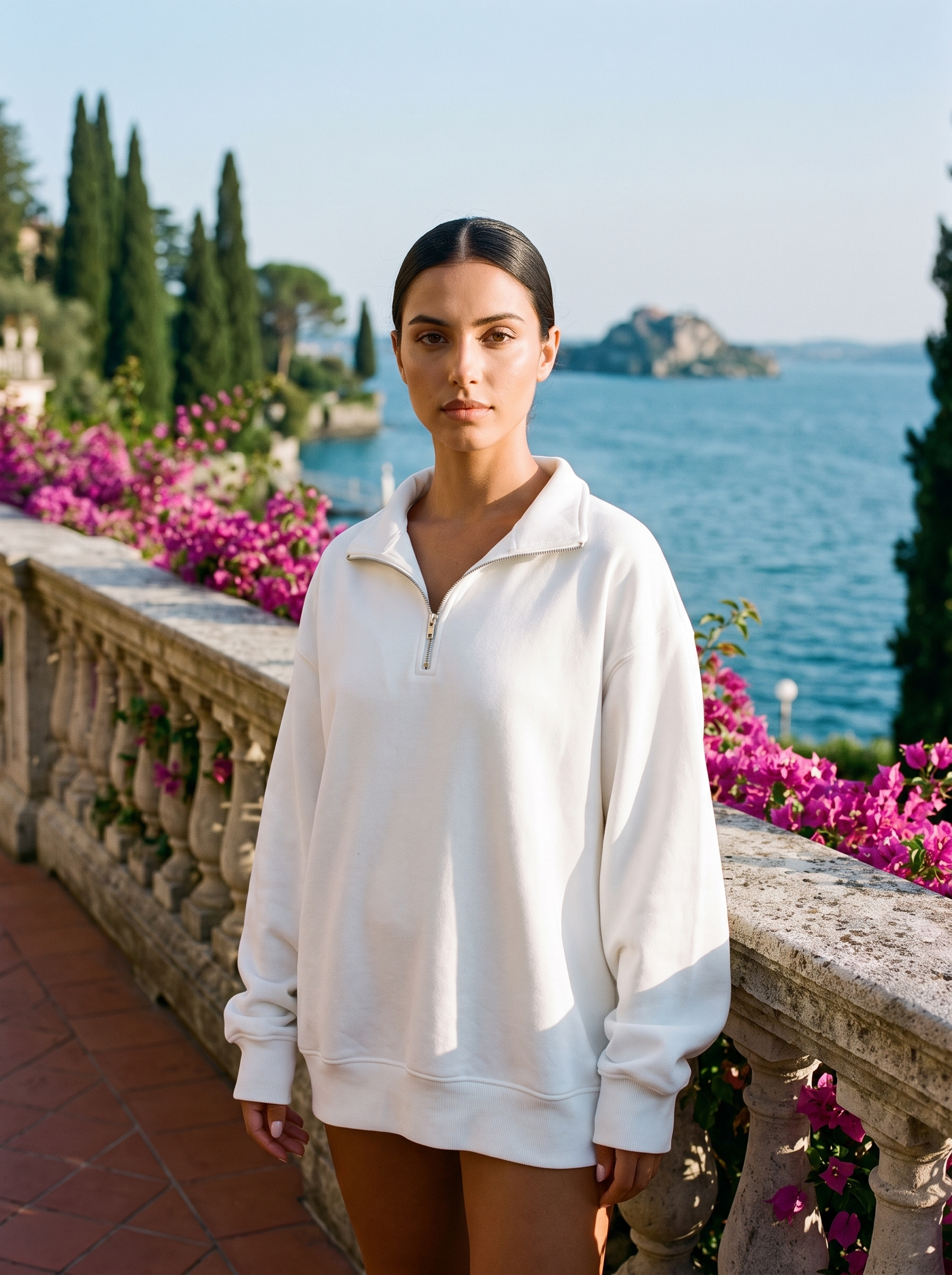 Woman wearing a white half-zip oversized sweatshirt on a Lake Como terrace — Aveloire
