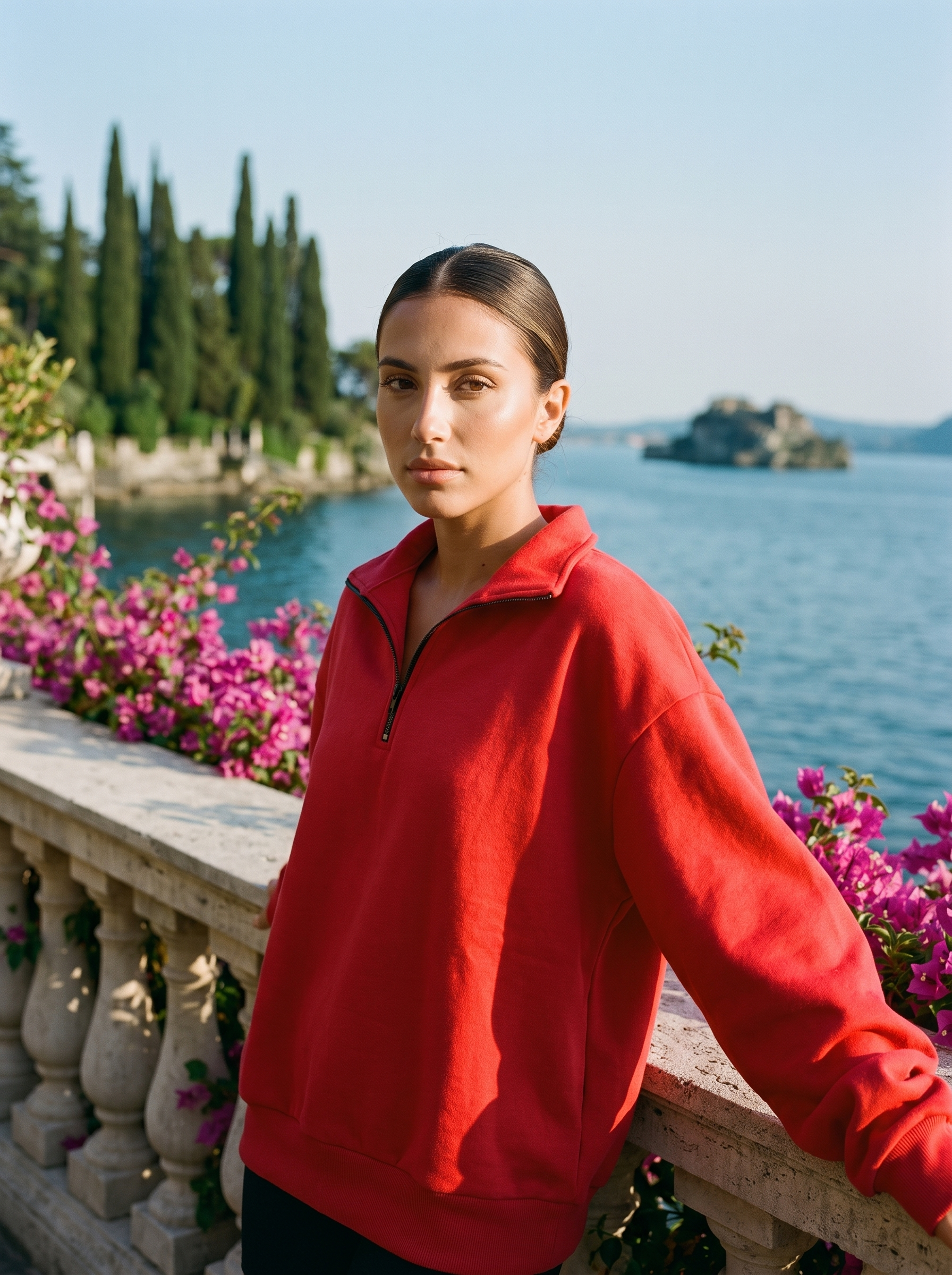 Woman wearing a red half-zip oversized sweatshirt on a Lake Como terrace — Aveloire