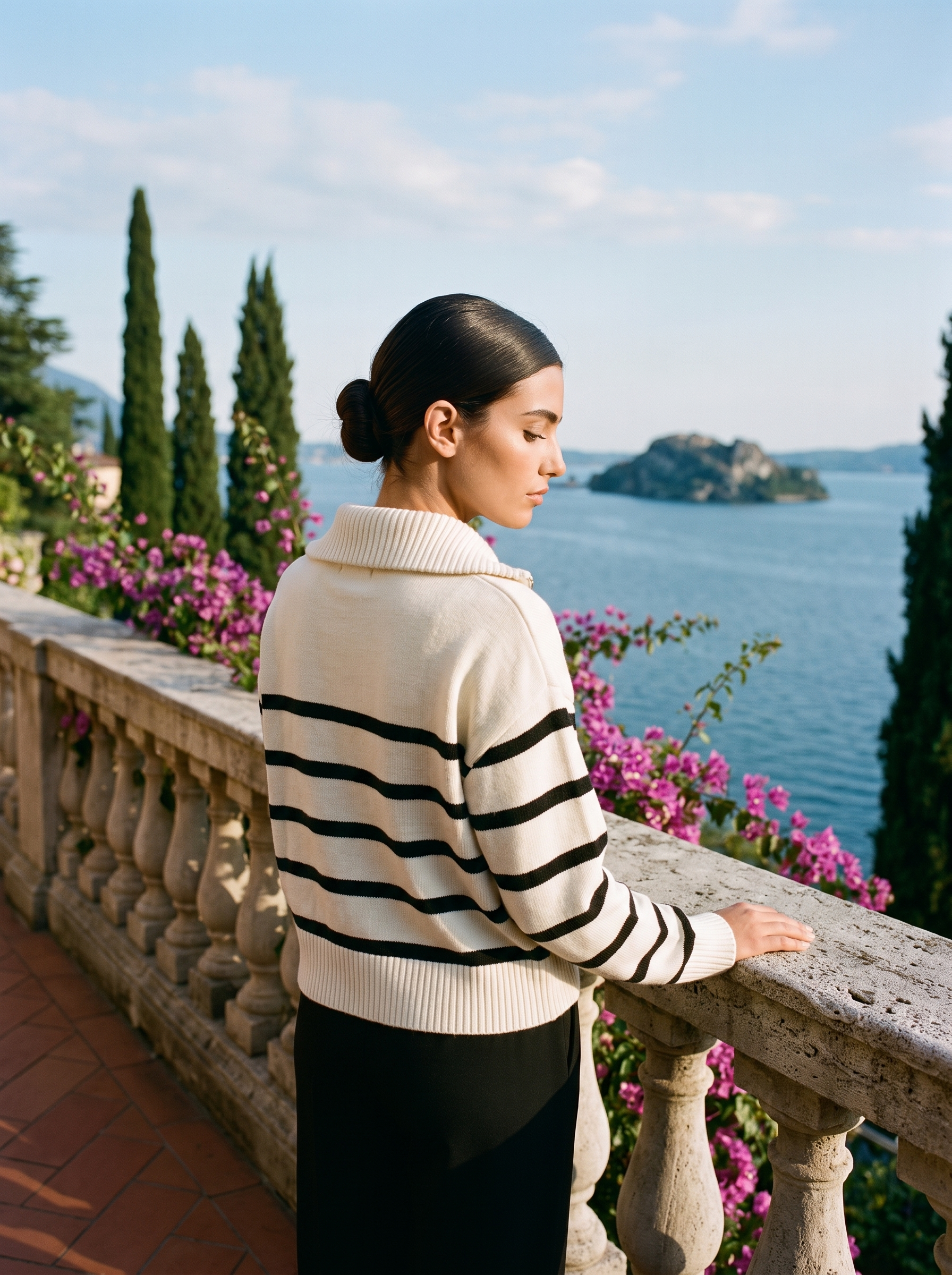 Back view of a cream and black striped quarter-zip polo sweater on a Lake Como terrace — Aveloire