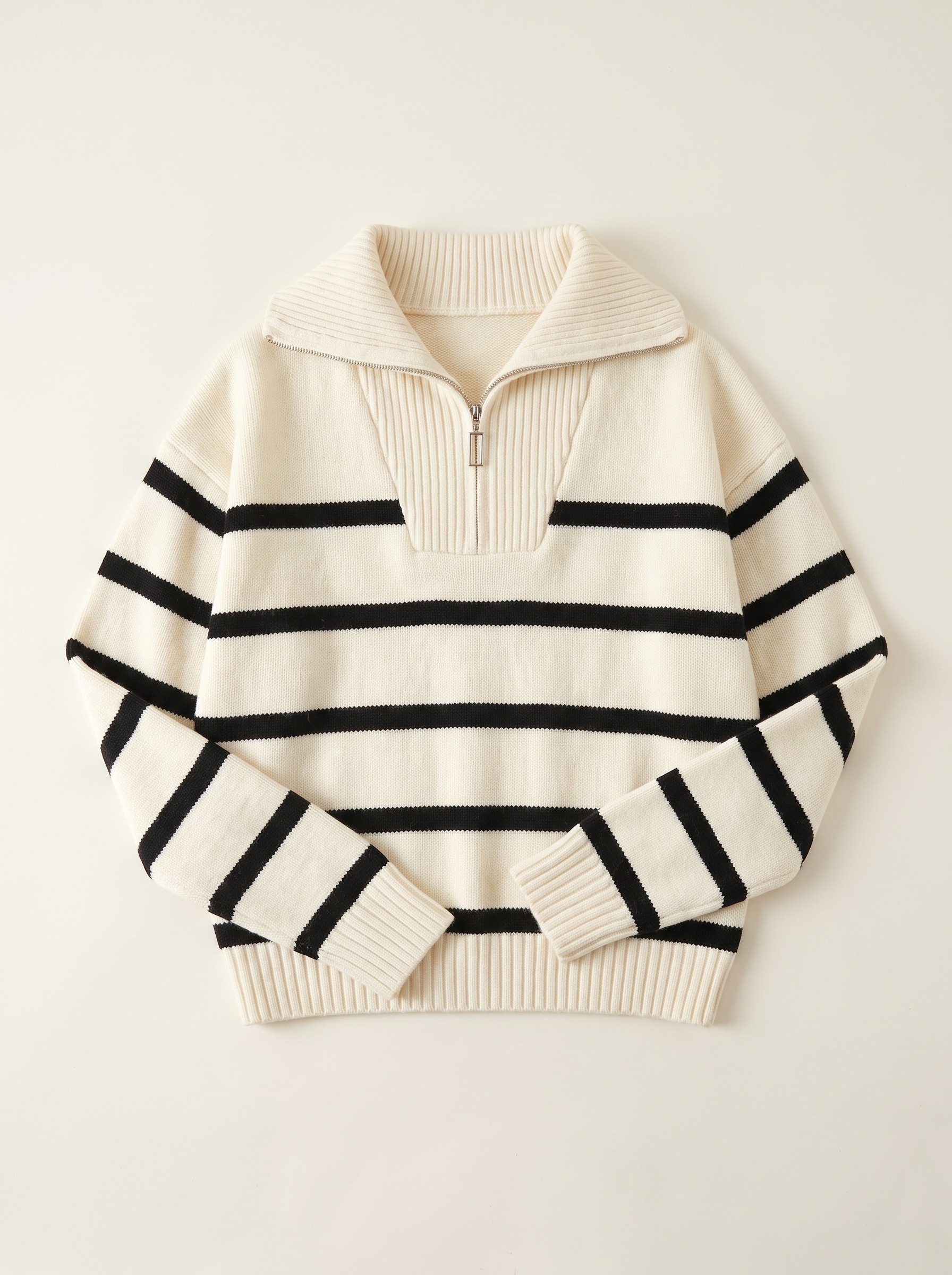 Cream and black striped quarter-zip polo sweater flat lay product photo — Aveloire
