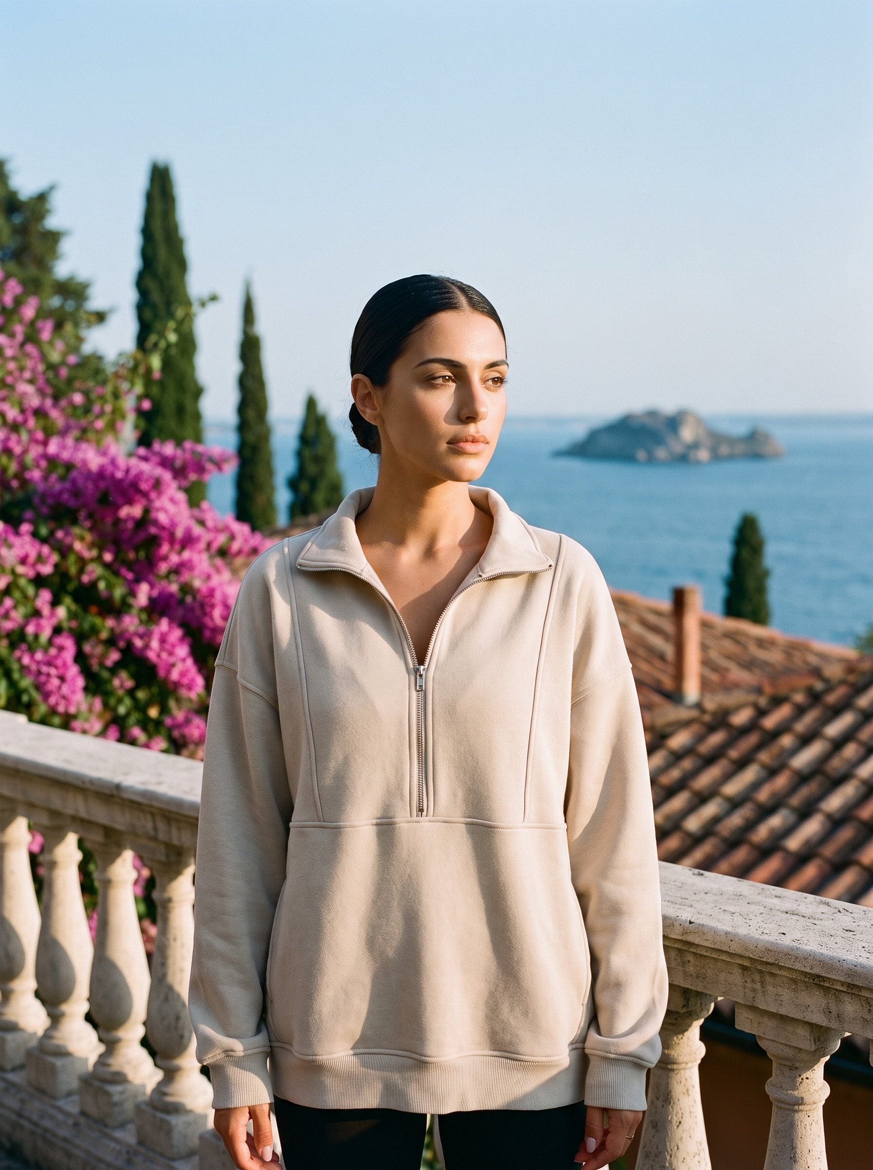 Woman wearing a beige oversized half-zip pocket sweatshirt on a Lake Como terrace, old money style — Aveloire