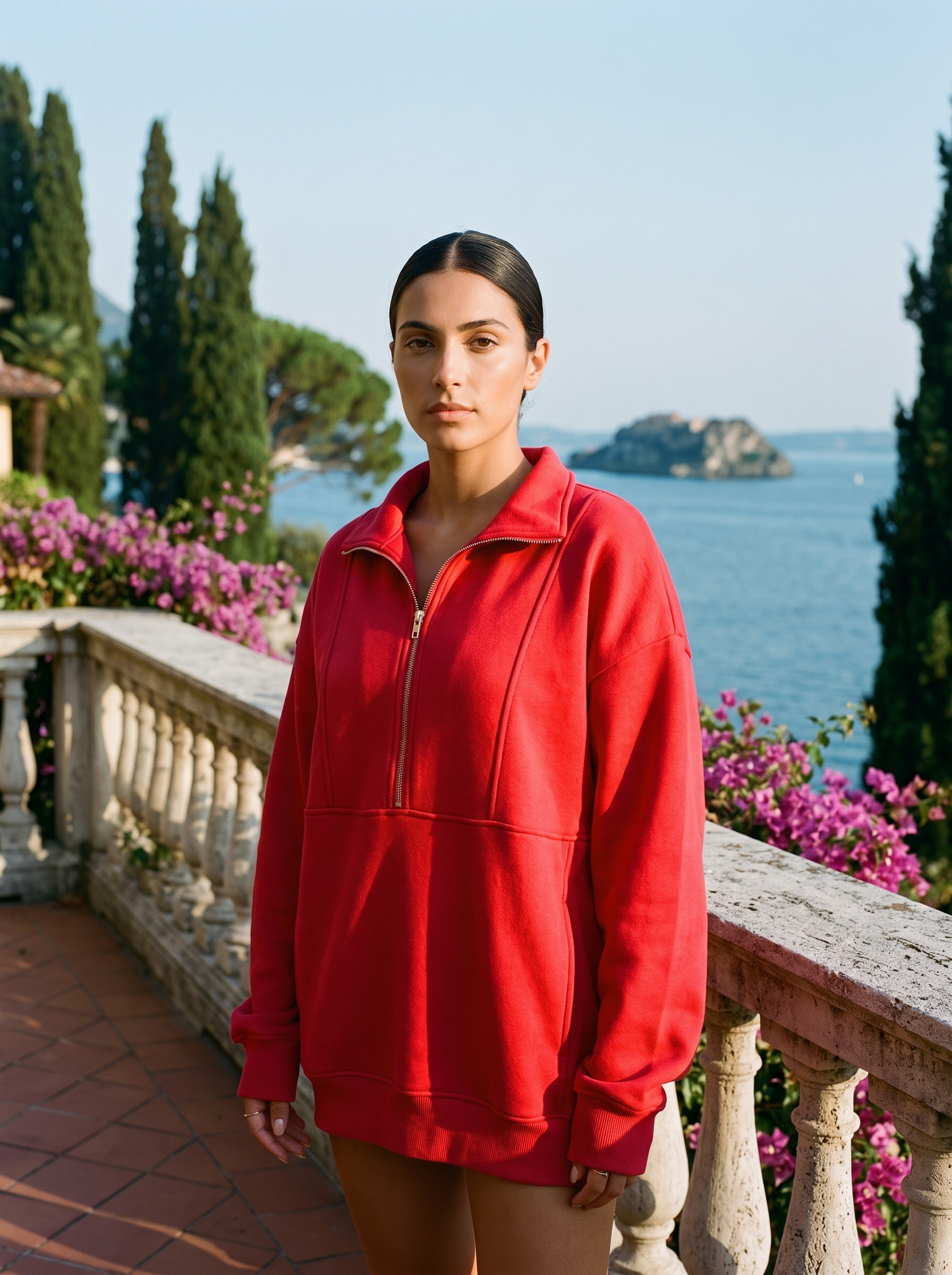 Woman wearing a red oversized half-zip pocket sweatshirt on a Lake Como terrace — Aveloire