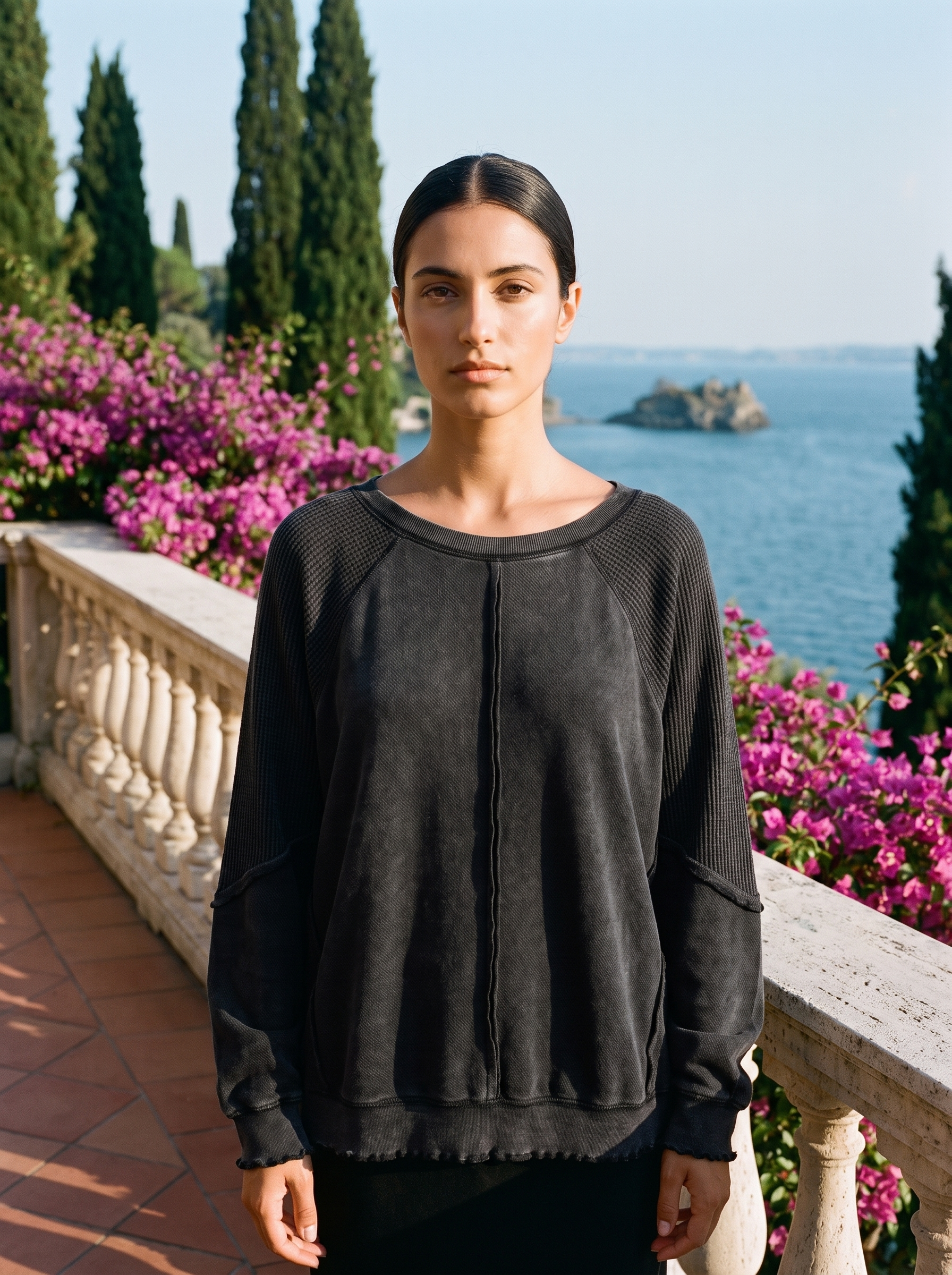 Woman wearing a black waffle-panel top on a Lake Como terrace — Aveloire