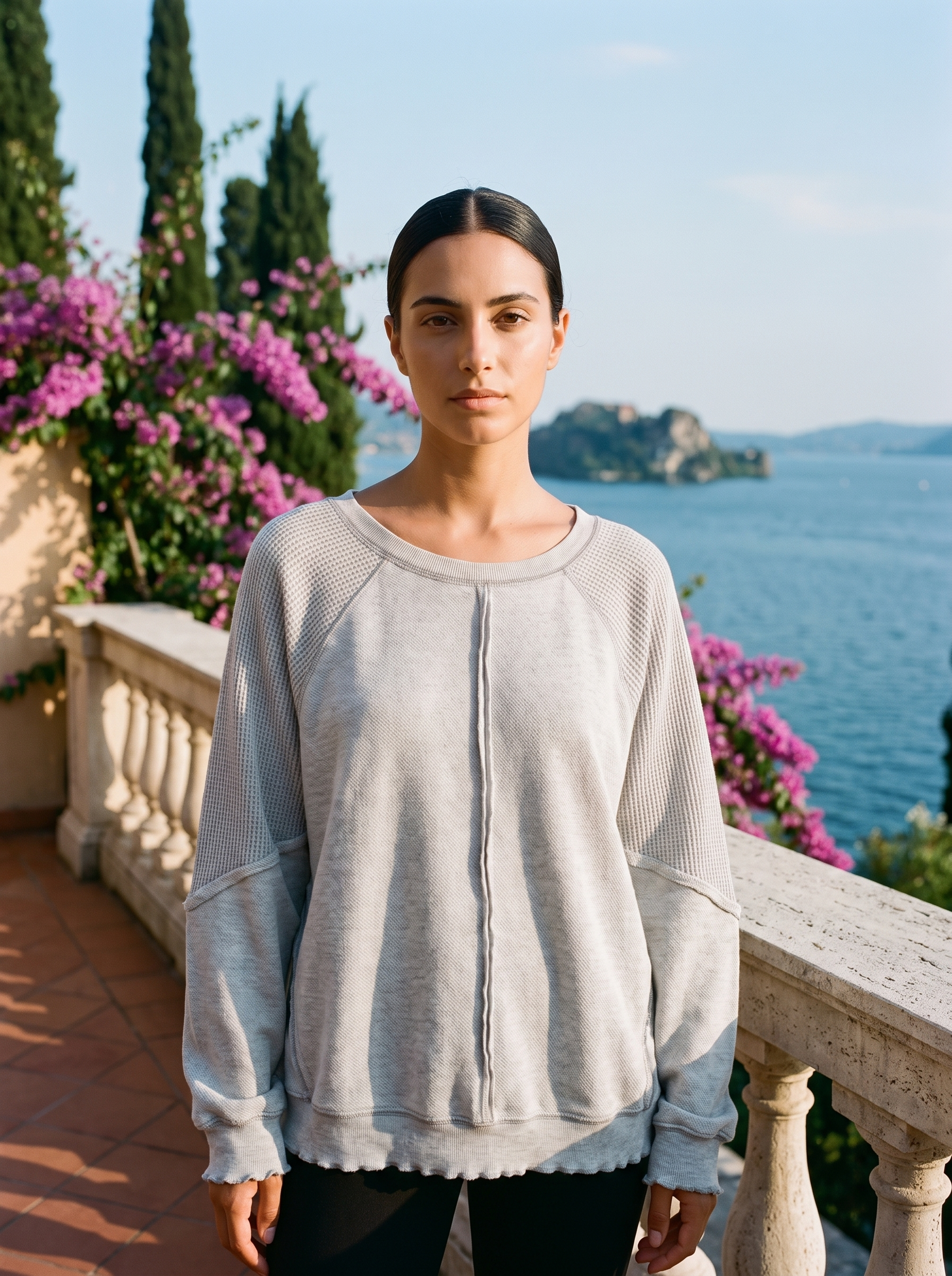 Woman wearing a heather gray waffle-panel top on a Lake Como terrace — Aveloire