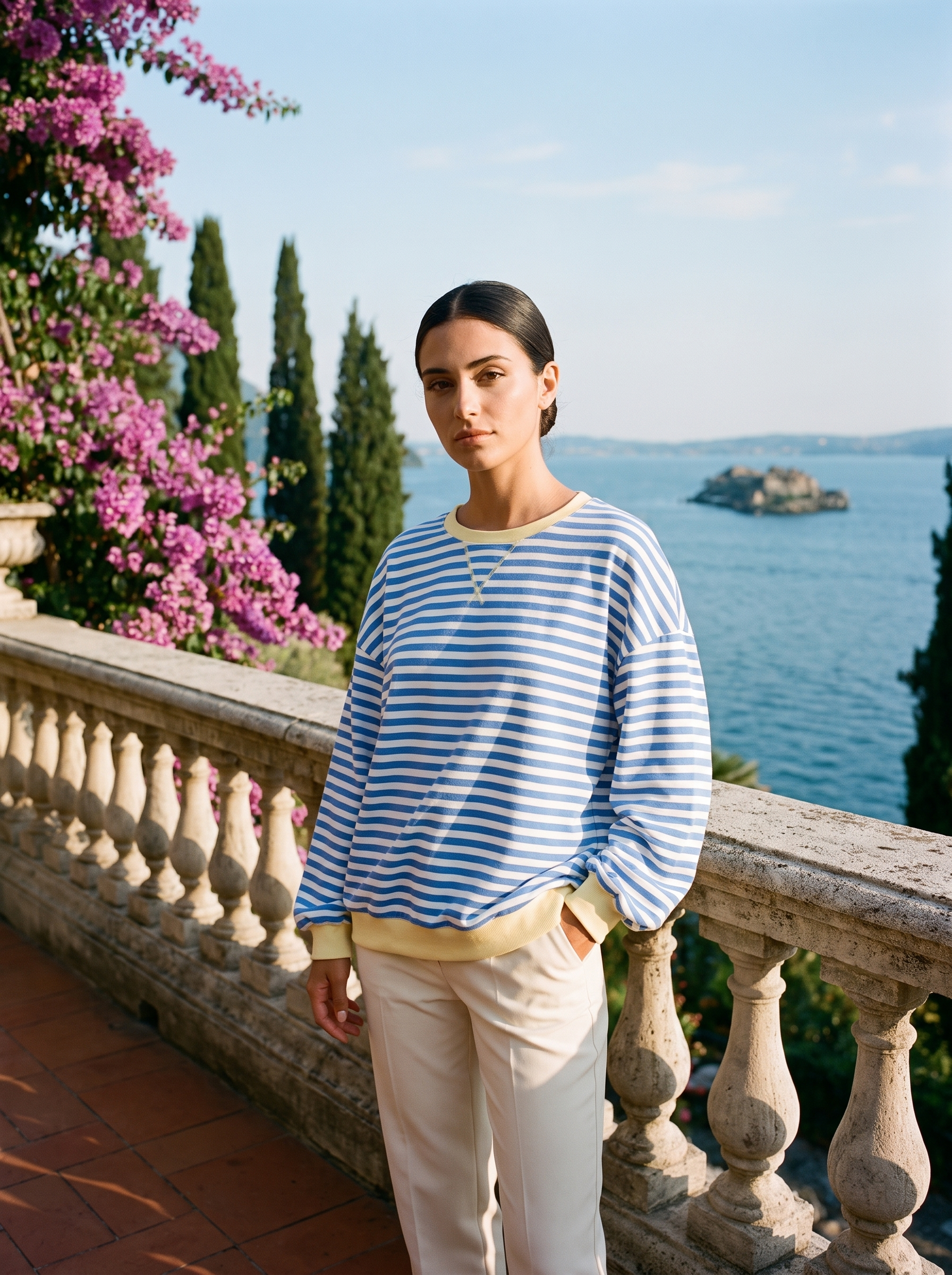 Full-length view of a blue and white striped oversized sweatshirt on a Lake Como terrace — Aveloire