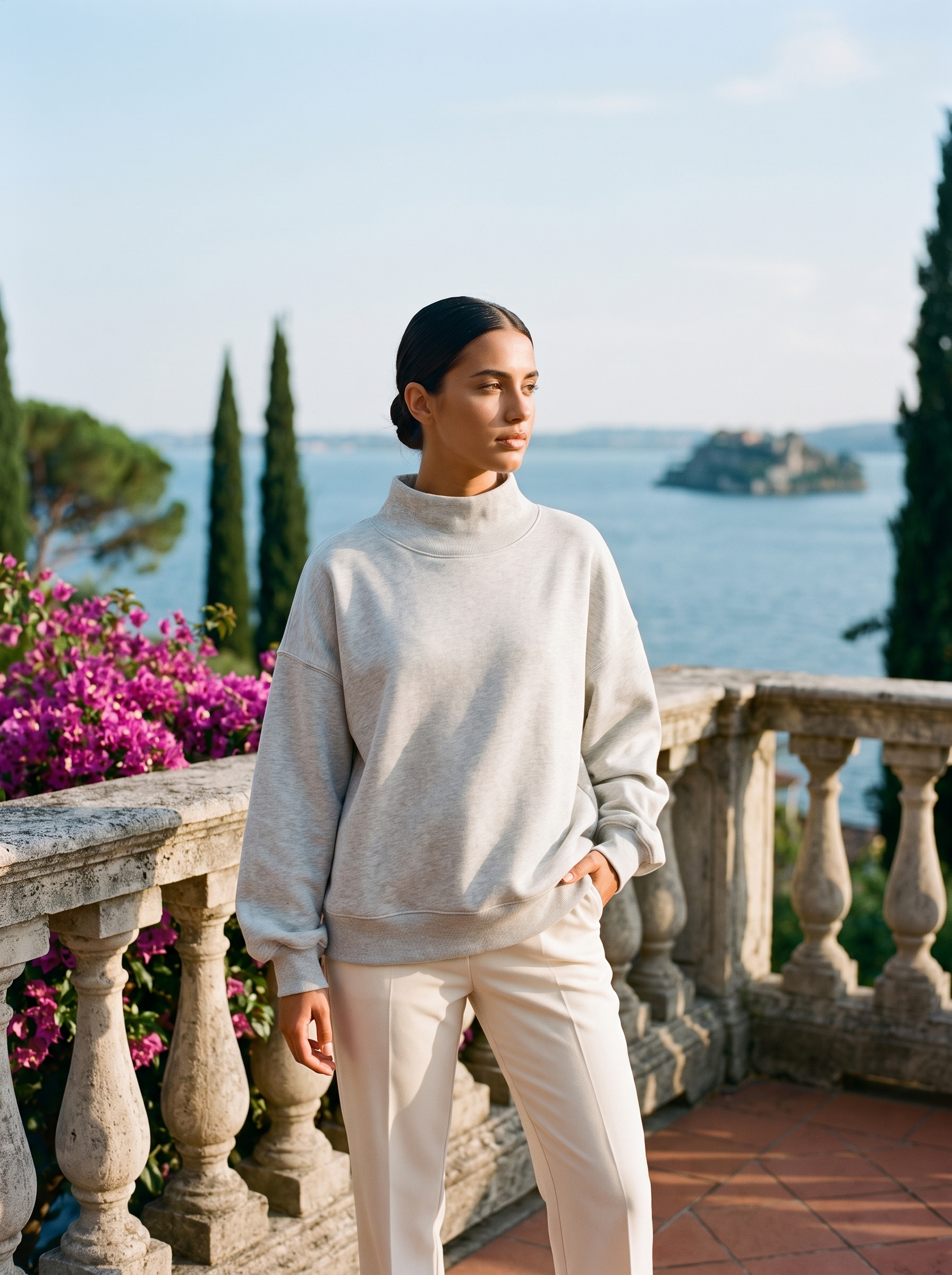 Full-length view of a light gray oversized turtleneck sweatshirt on a Lake Como terrace — Aveloire