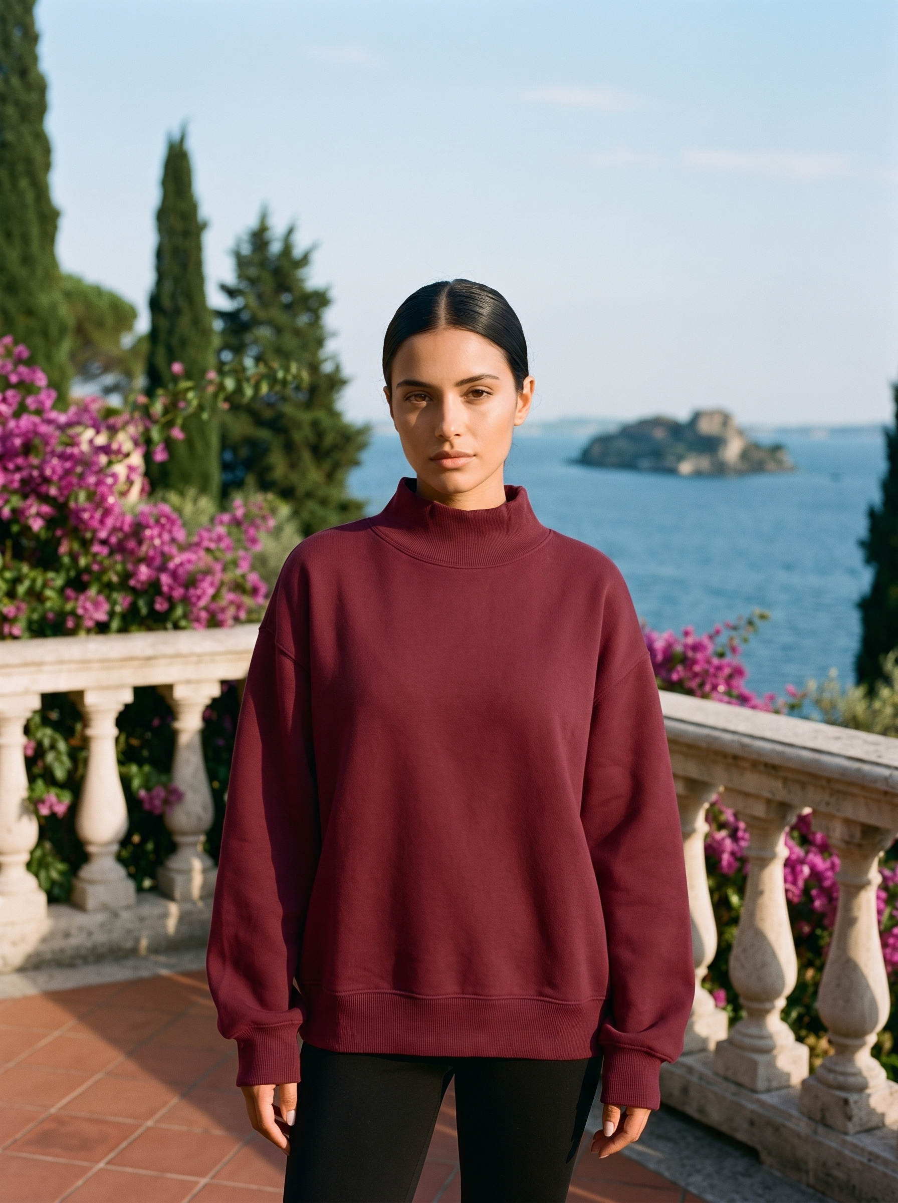 Woman wearing a wine red oversized turtleneck sweatshirt on a Lake Como terrace — Aveloire