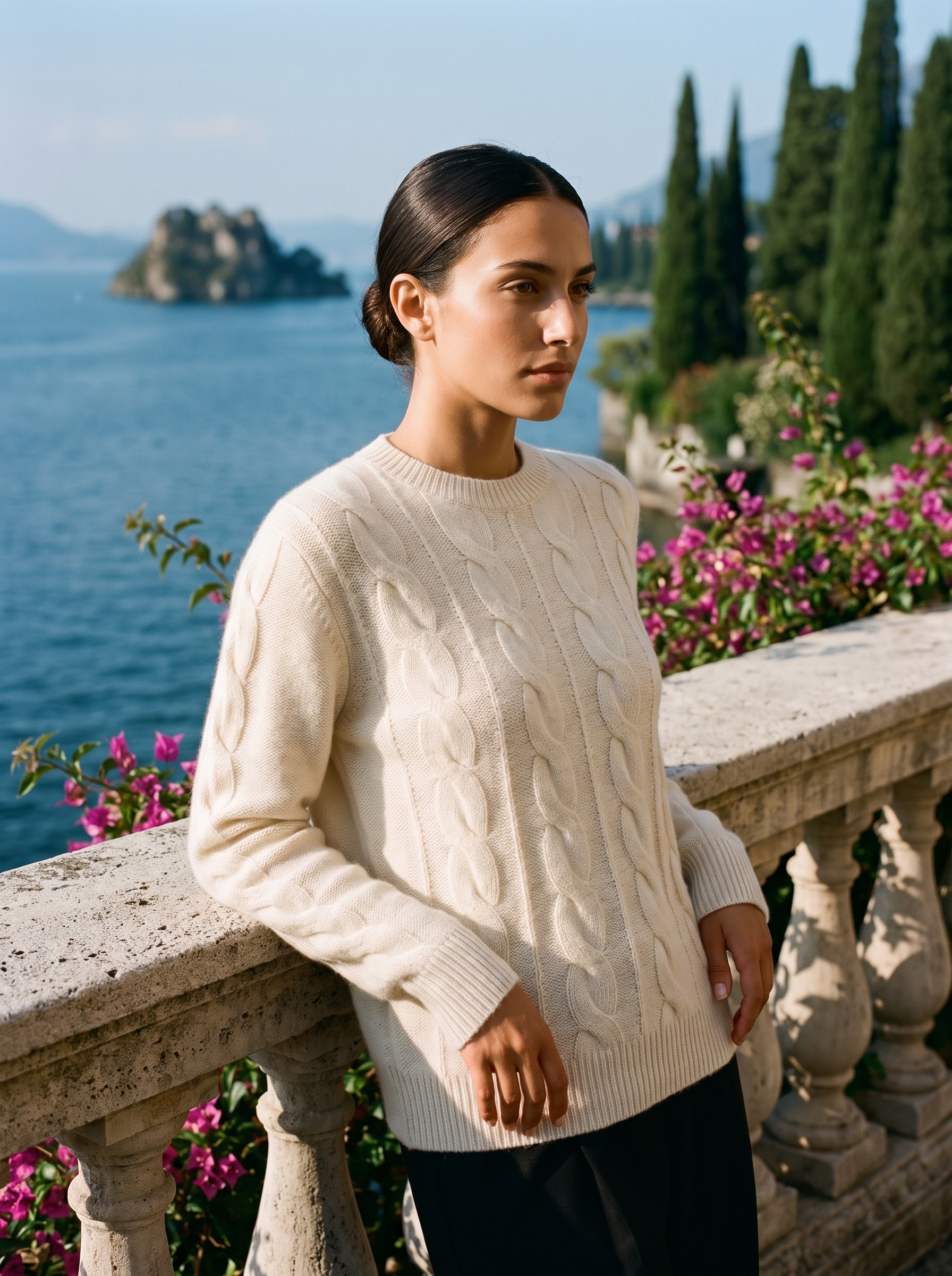 Woman wearing a cream cable-knit crew neck sweater on a Lake Como terrace, old money style — Aveloire