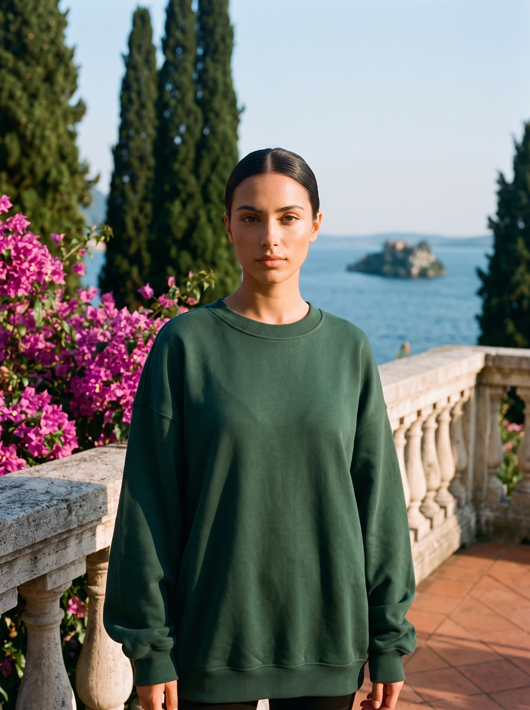 Woman wearing a forest green oversized crew neck sweatshirt on a Lake Como terrace, old money style — Aveloire
