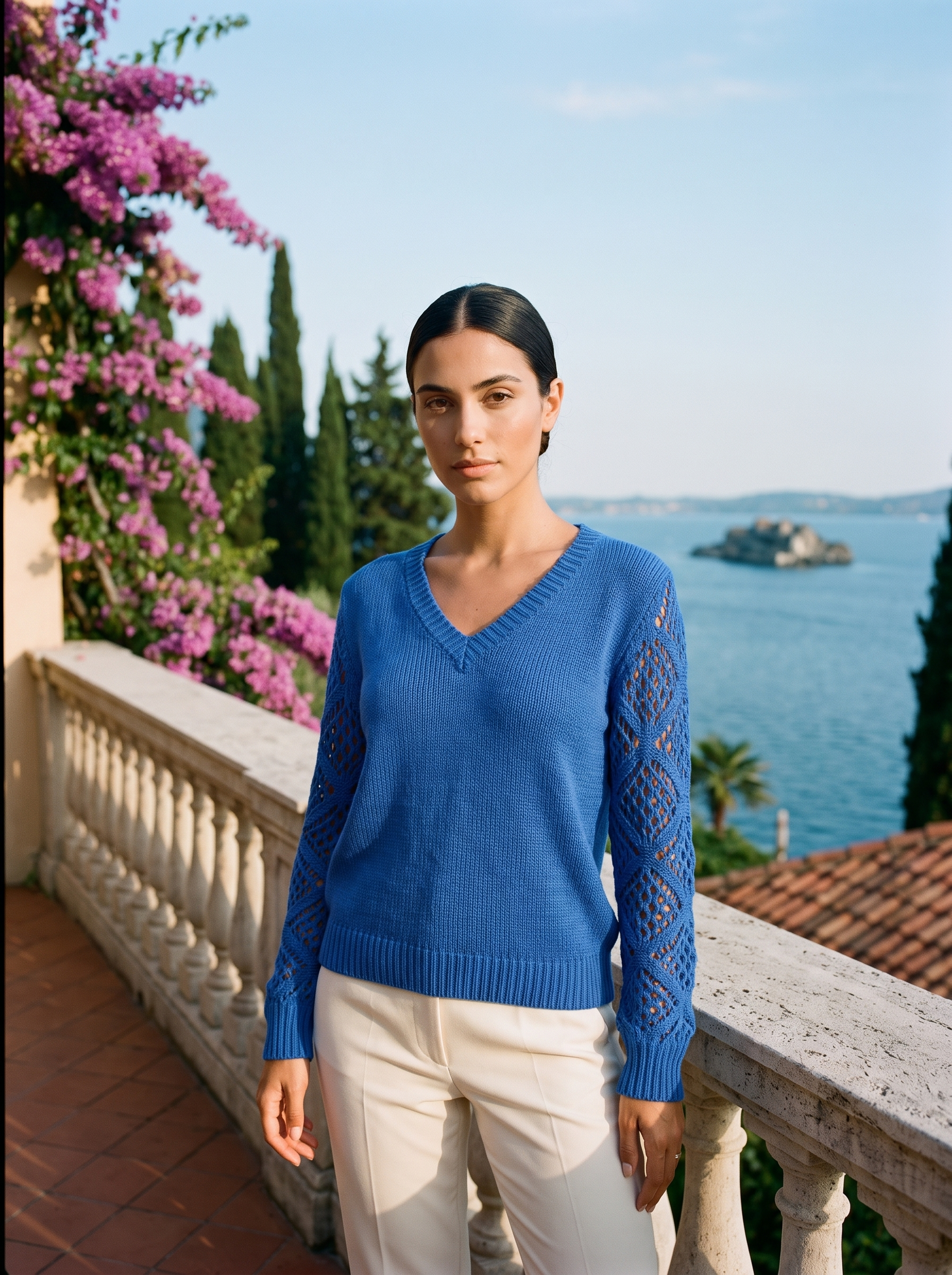 Woman wearing a cobalt blue V-neck knit jumper on a Lake Como terrace, old money style — Aveloire