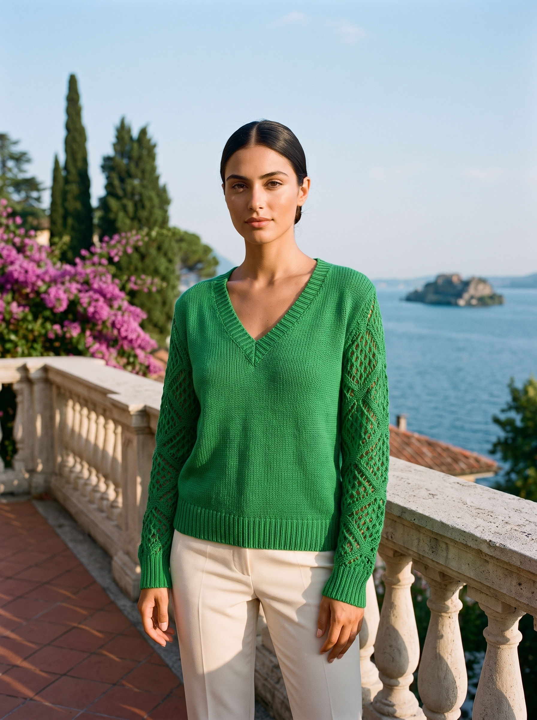 Woman wearing a kelly green V-neck knit jumper on a Lake Como terrace, old money style — Aveloire