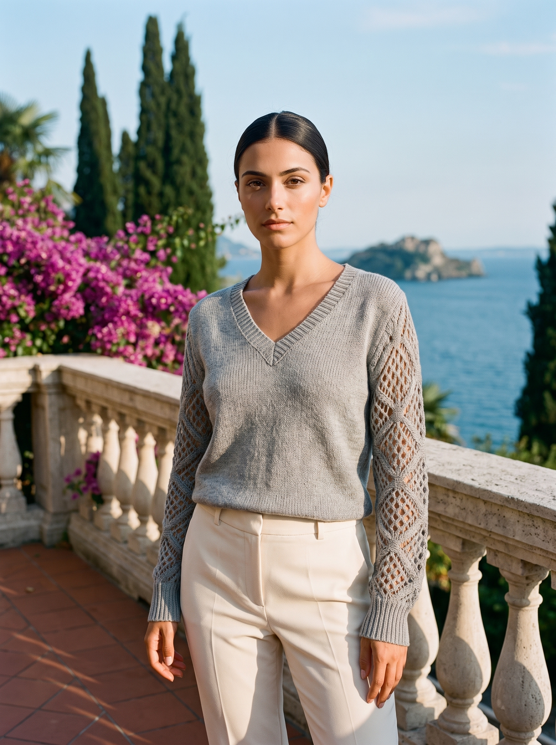 Woman wearing a heather grey V-neck knit jumper on a Lake Como terrace, old money style — Aveloire