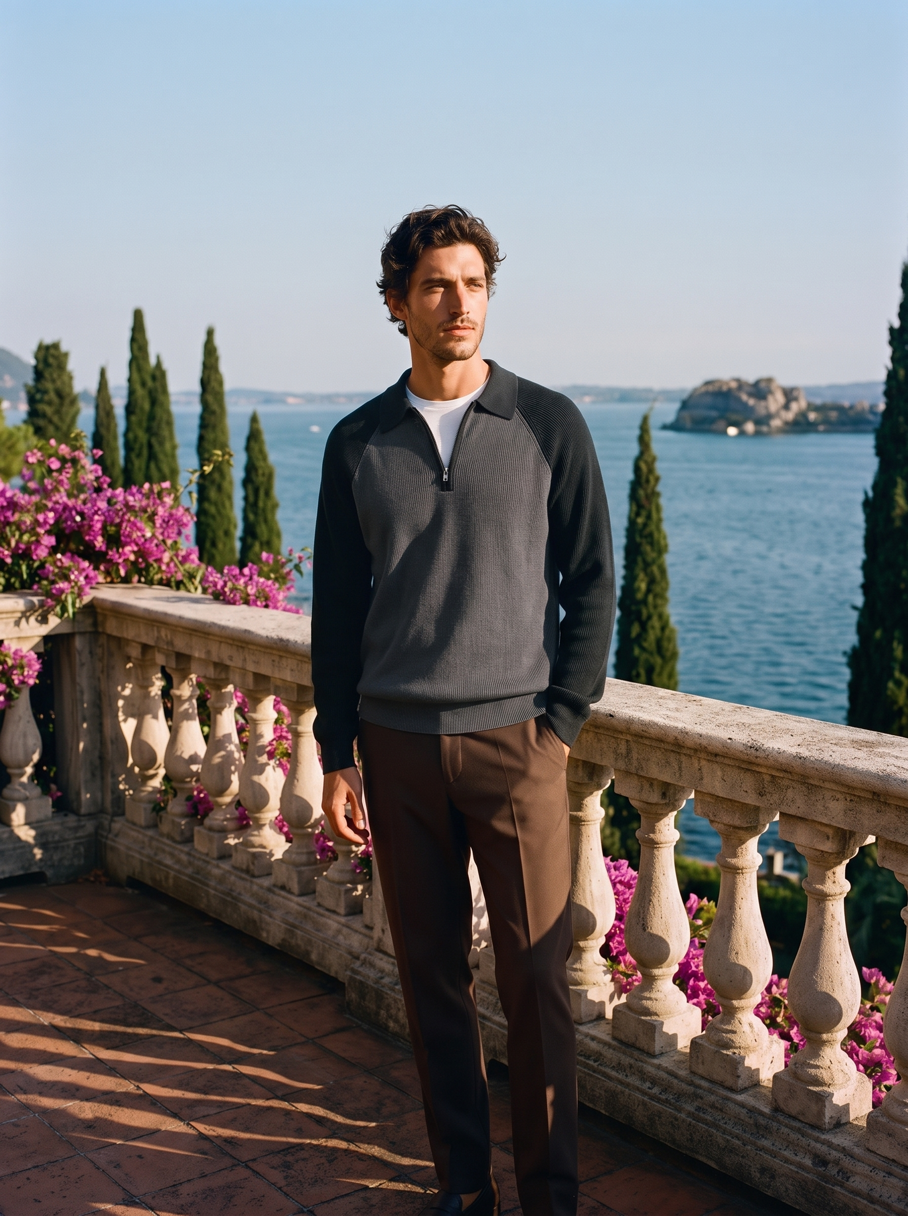 Man wearing a two-tone black half-zip knit polo sweater on a terrace overlooking Lake Como, old money style — Aveloire