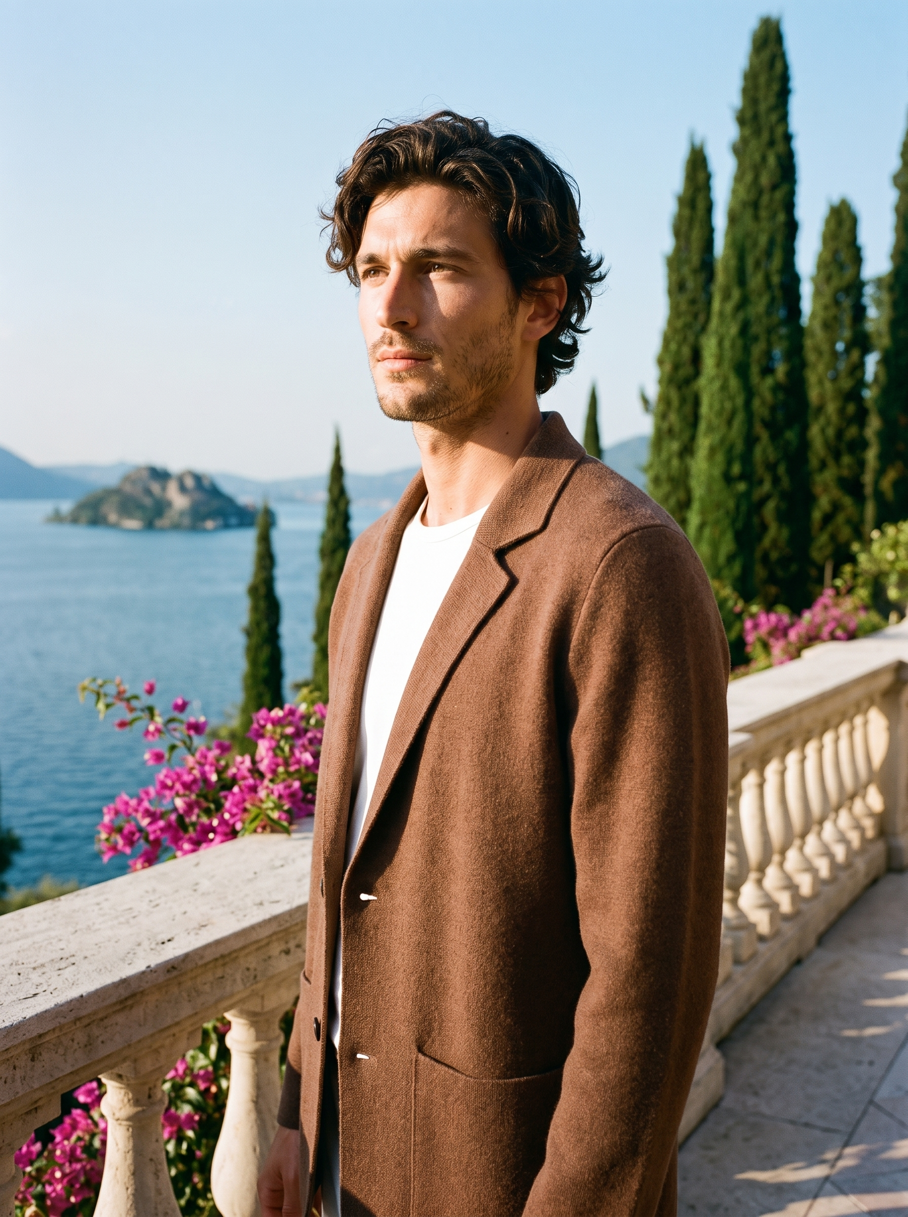 Man wearing a brown wool blazer cardigan on a terrace overlooking Lake Como, old money style — Aveloire