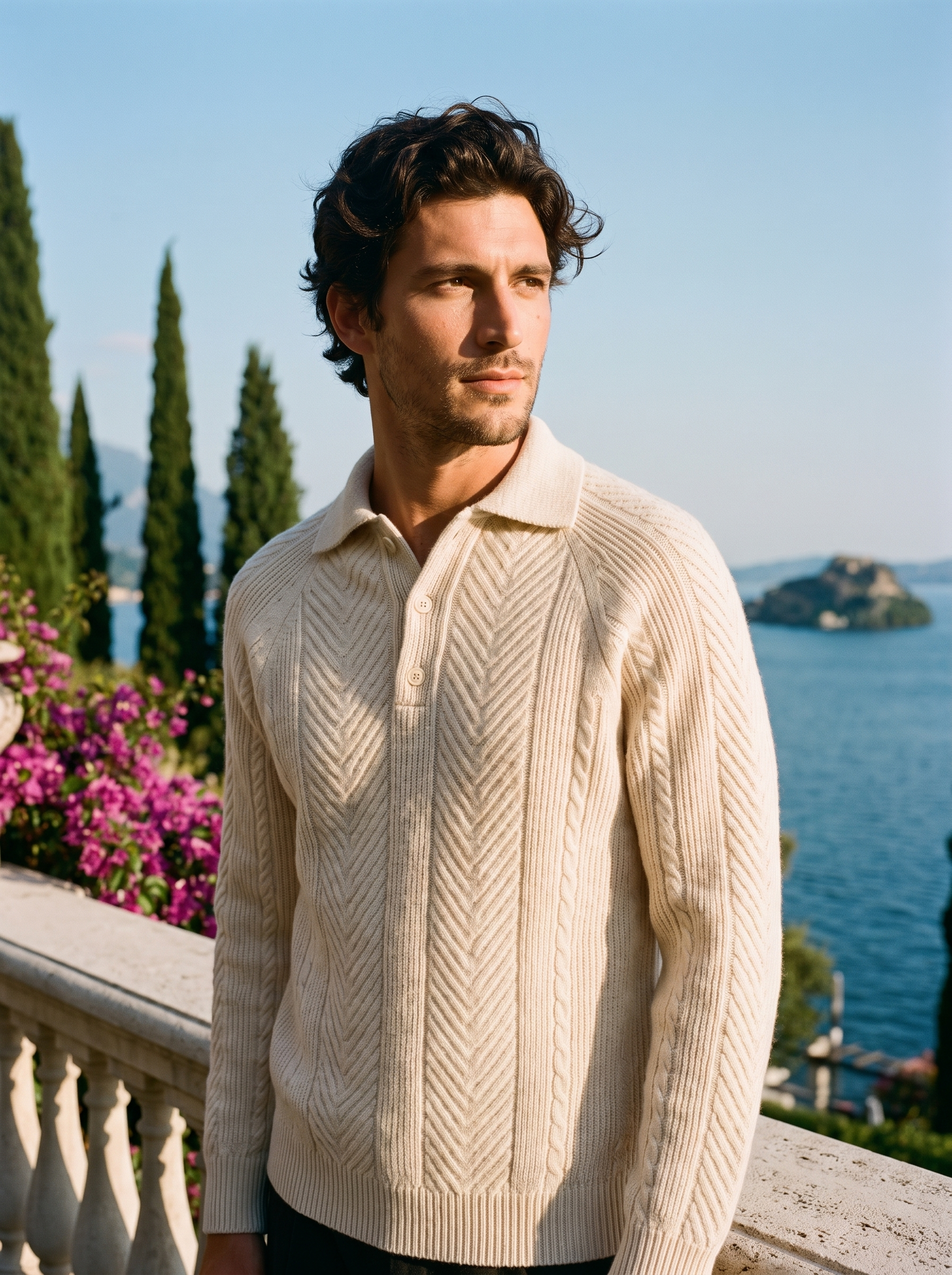 Man wearing a cream herringbone knit polo sweater on a terrace overlooking Lake Como, old money style — Aveloire