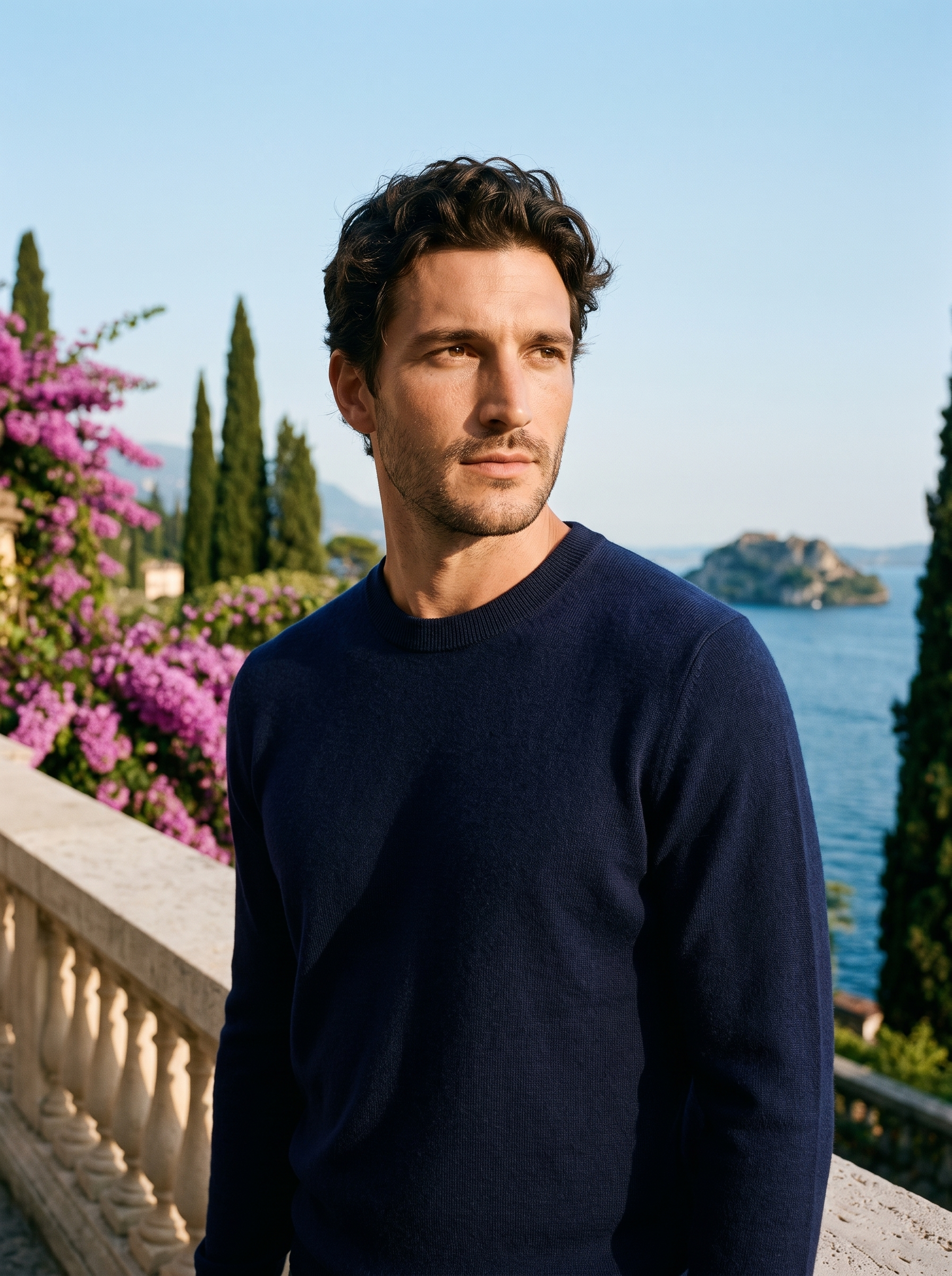 Man wearing a navy 100% wool crewneck sweater on a terrace overlooking Lake Como, old money style — Aveloire