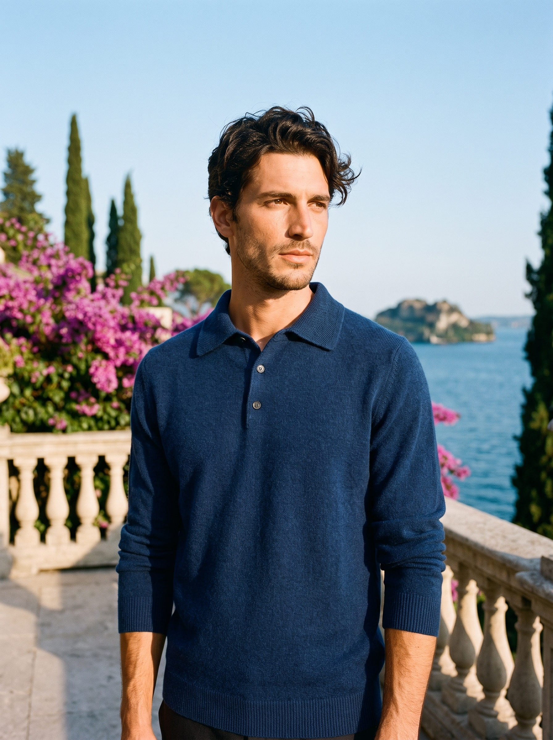 Man wearing a navy wool knit polo sweater on a terrace overlooking Lake Como, old money style — Aveloire