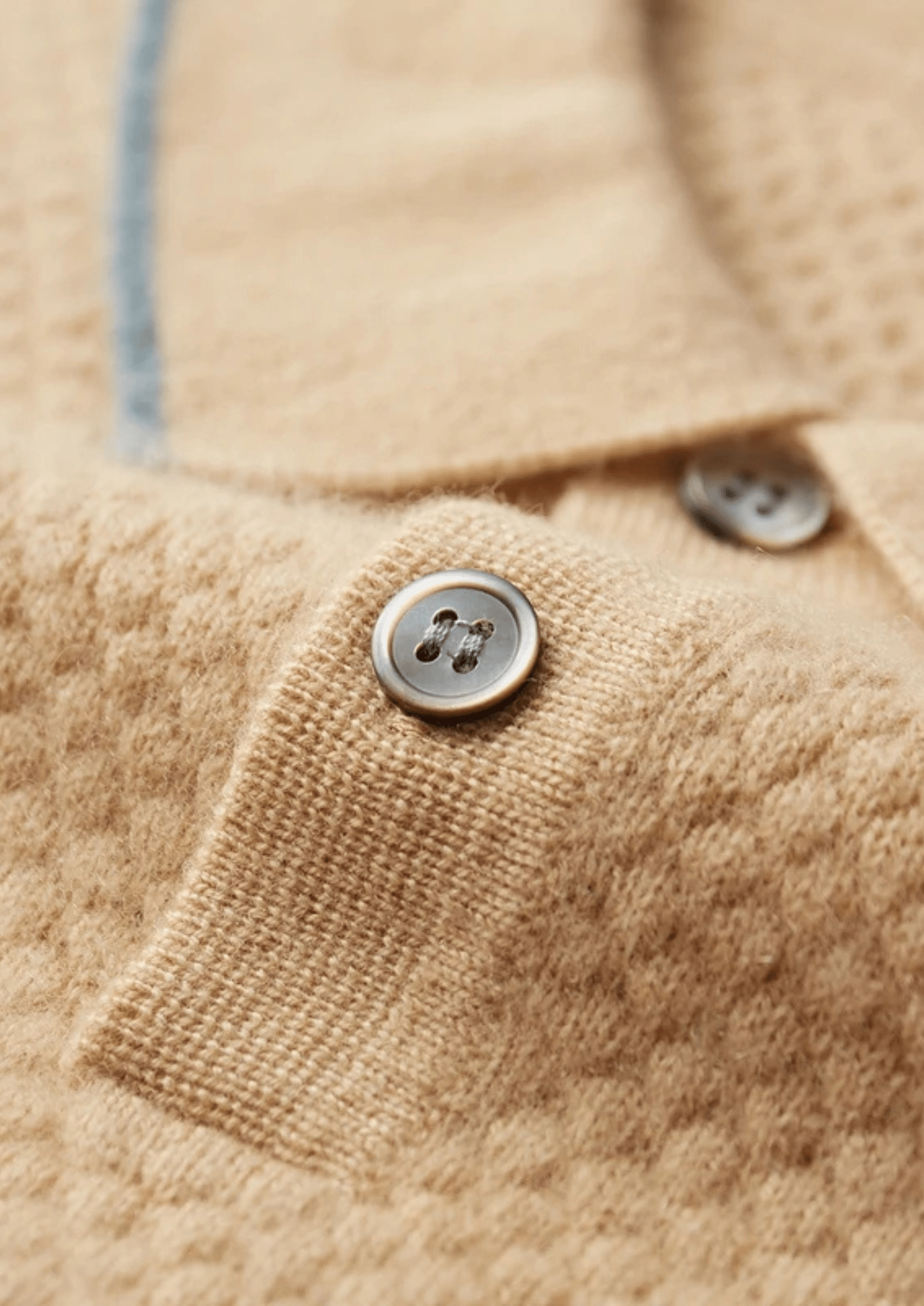 Close-up of a beige fabric texture with buttons