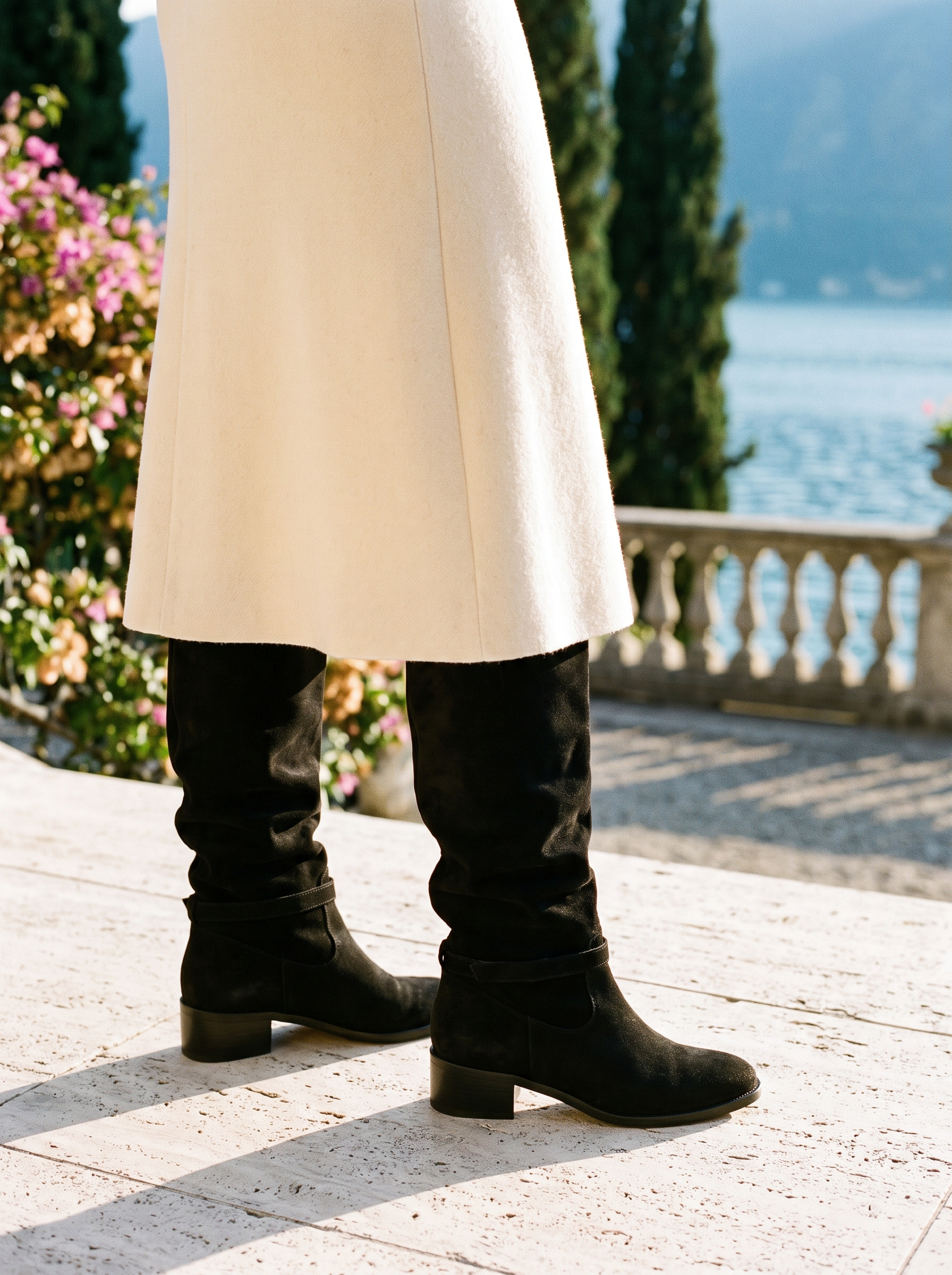 Woman wearing black suede-look slouch knee high boots