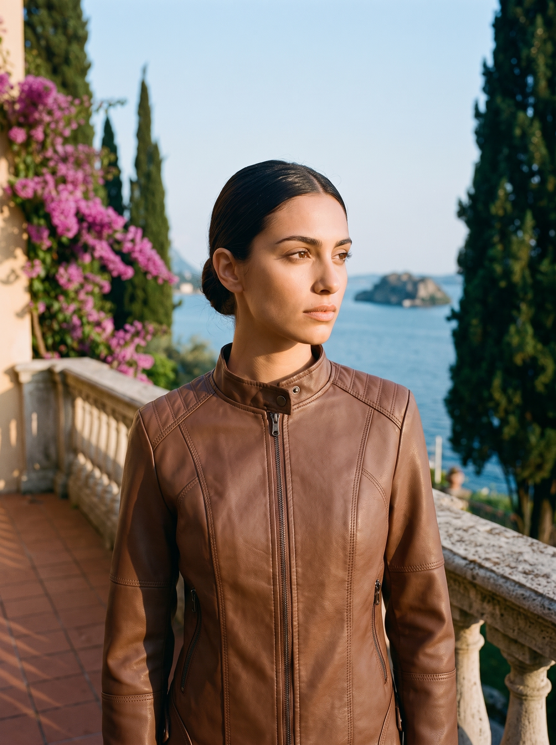 Woman wearing brown sleek jacket on a Lake Como terrace — Aveloire