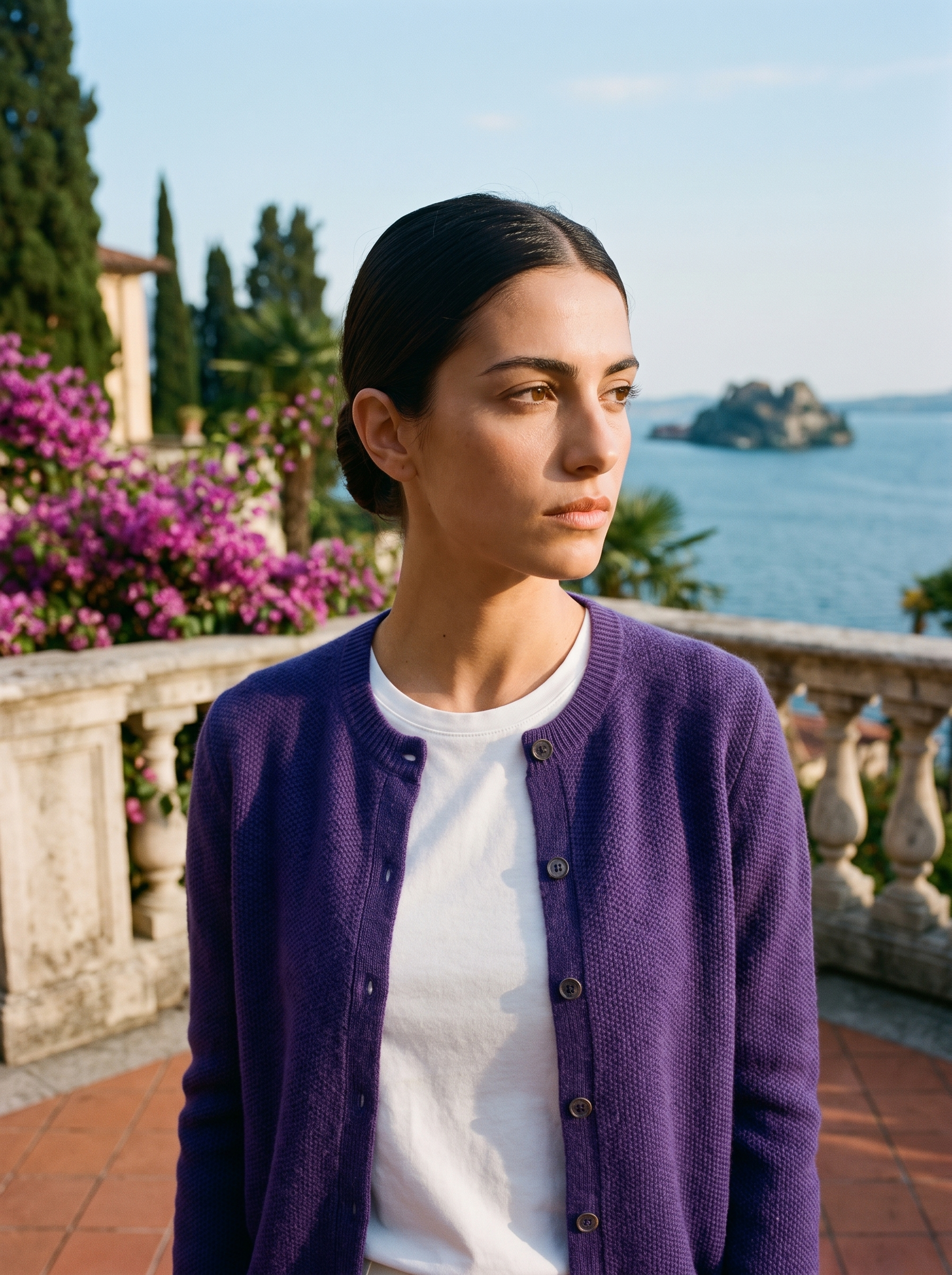 Woman wearing a dark purple wool-blend cardigan on a terrace overlooking Lake Como, old money style — Aveloire