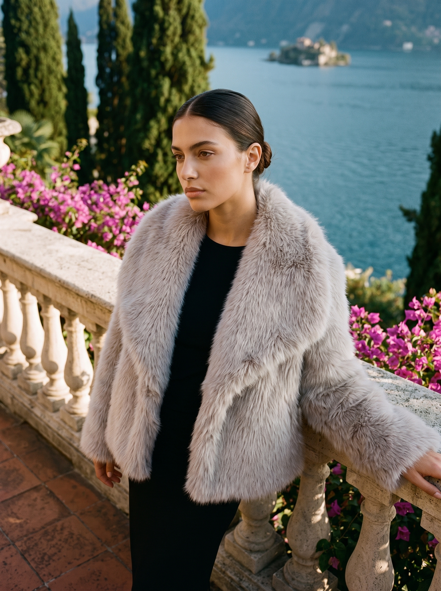 Woman wearing a dove-grey cropped faux fur coat on a Lake Como terrace — Aveloire