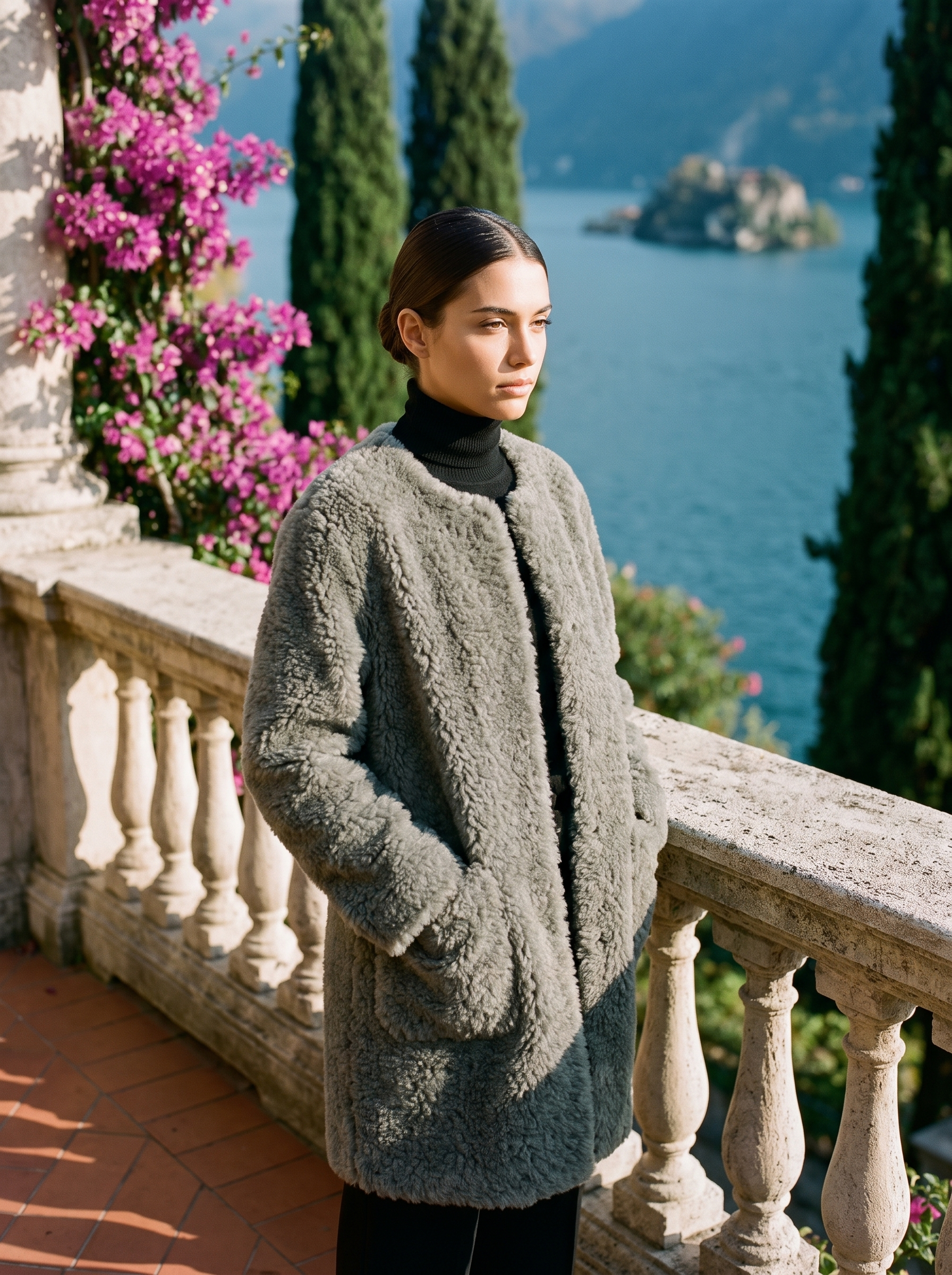 Woman wearing a heather-grey shearling teddy coat on a Lake Como terrace — Aveloire